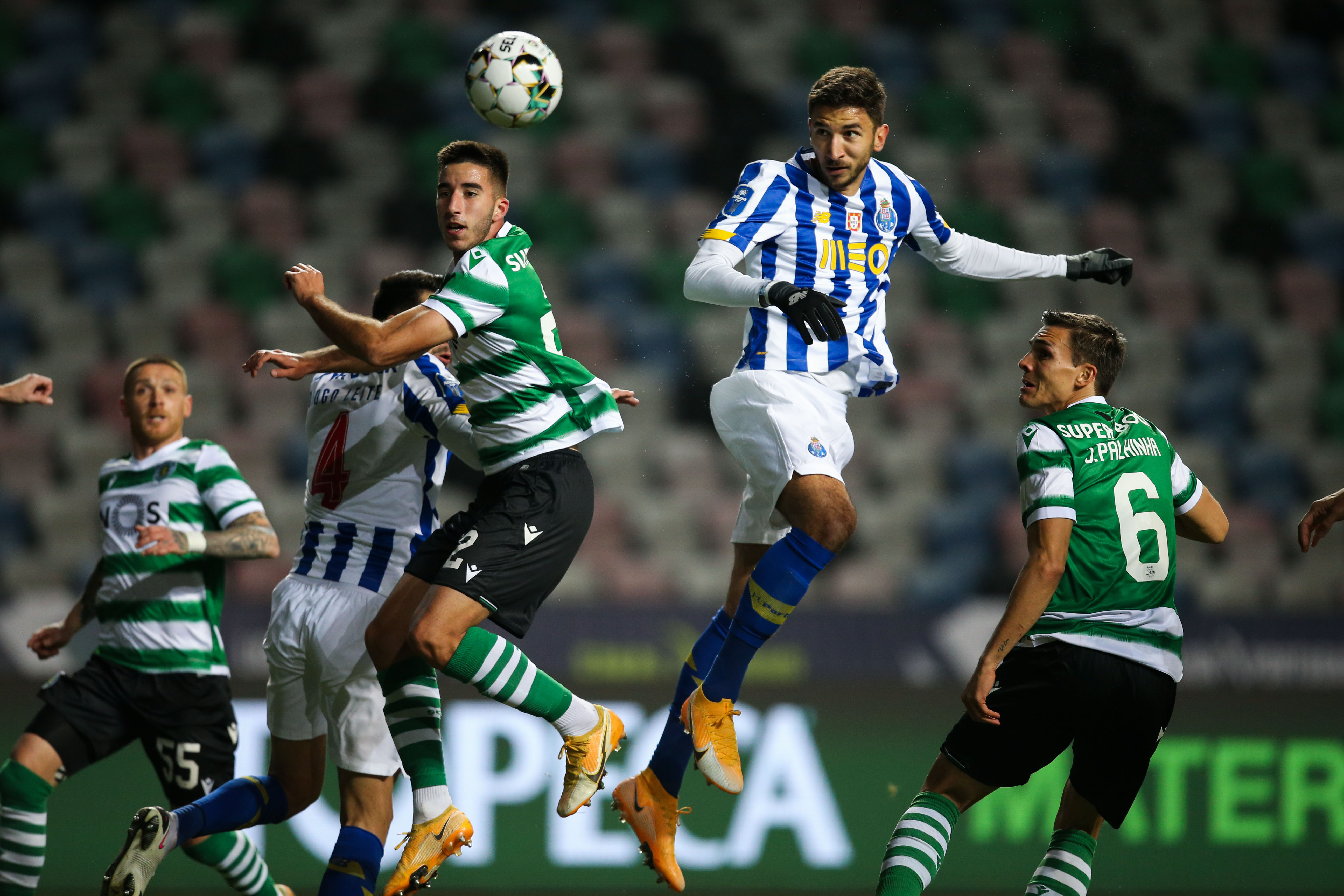 epa08950039 Sporting`s Gonçalo Inacio (L) fights for the ball with FC Porto`s Marko Grujic (C) during their Portuguese League Cup semi final soccer match held at Magalhaes Pessoa stadium, Leiria, Portugal, 19 January 2021.  EPA-EFE/PAULO CUNHA