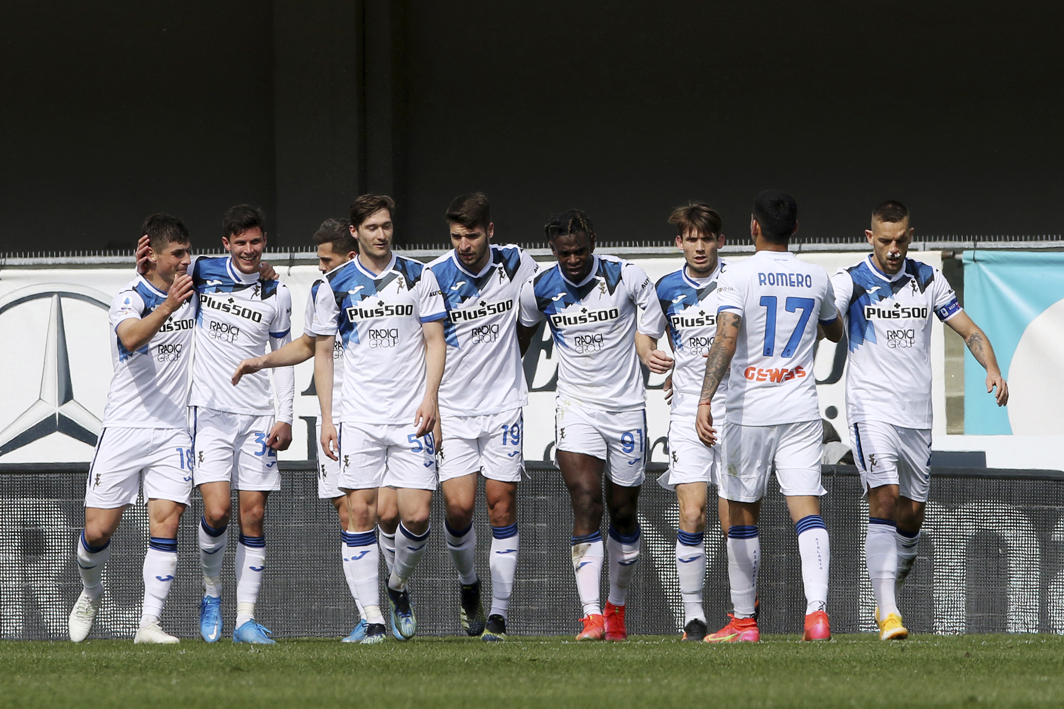 Atalanta's Duvan Zapata, 4th from right, celebrates with teammates after scoring during the Serie A soccer match between Hellas Verona and Atalanta, at the Bentegodi stadium in Verona, Italy, Sunday, March 21, 2021. (Paola Garbuio/LaPresse via AP)