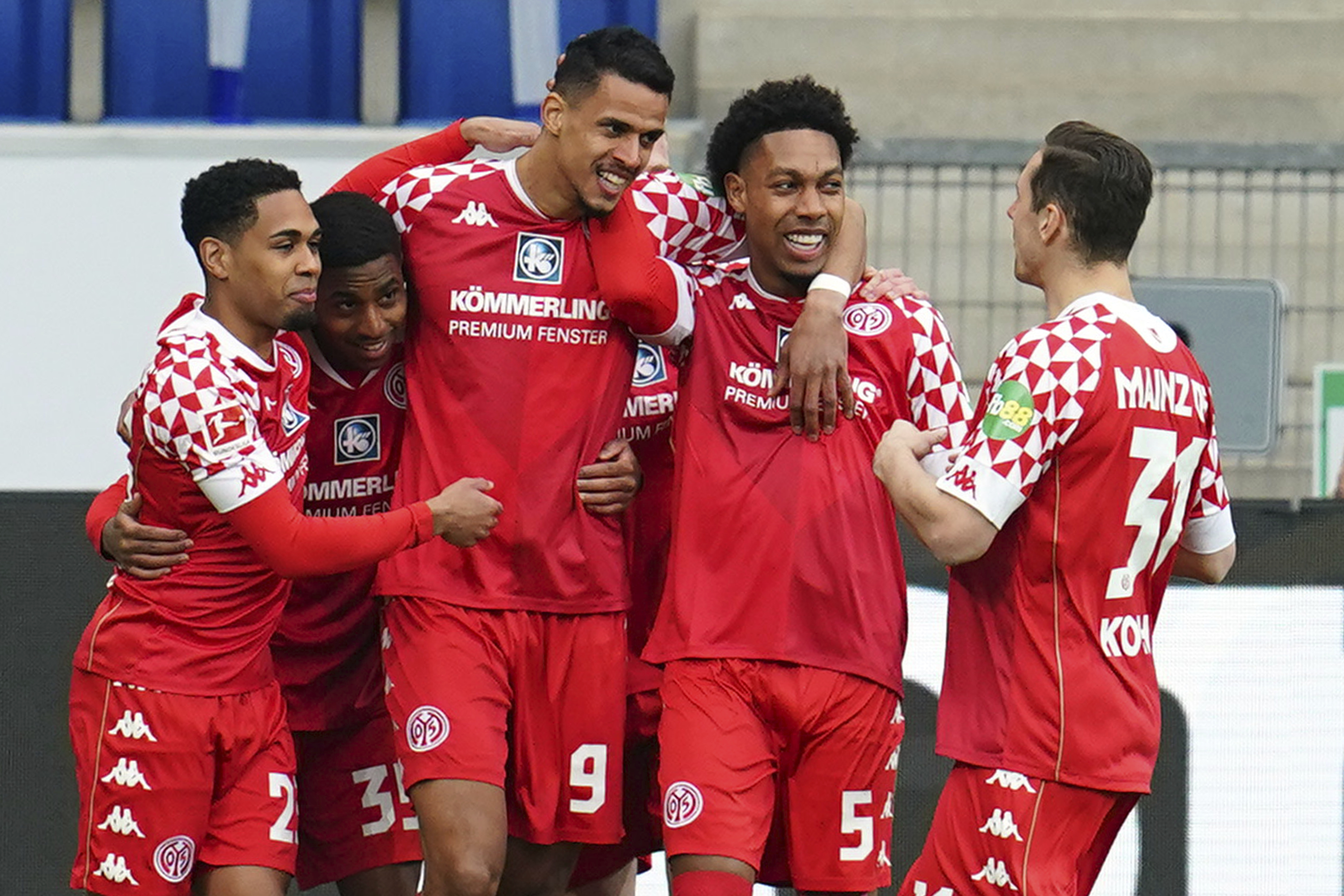 Mainz's players celebrate their side's opening goal during a German Bundesliga soccer match between TSG 1899 Hoffenheim and FSV Mainz 05 in Sinsheim, Germany, Sunday, March 21, 2021.  (Uwe Anspach/dpa via AP)