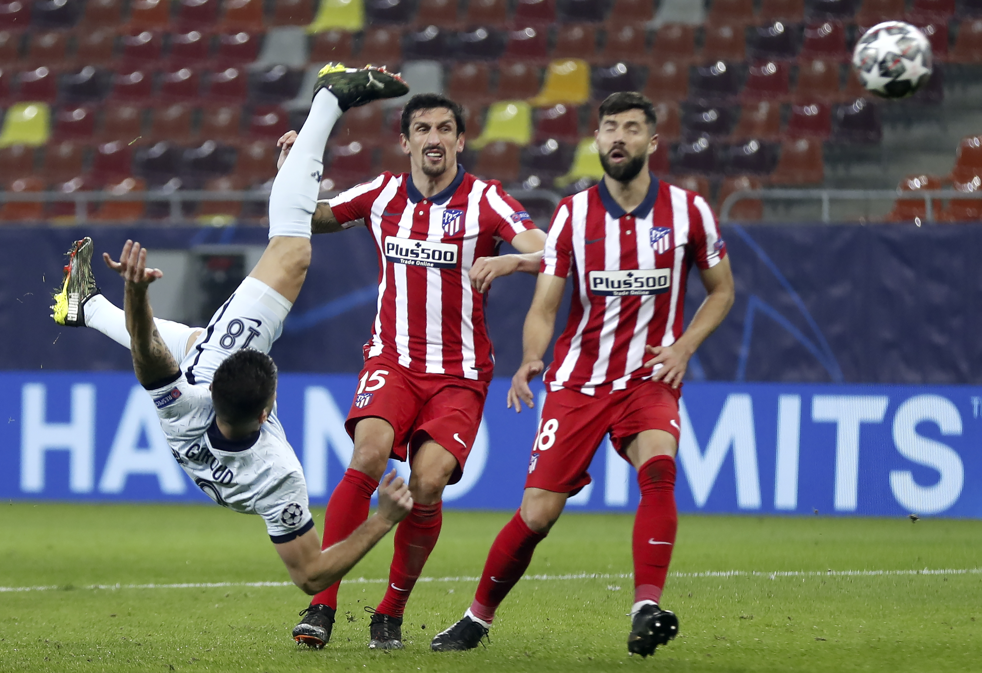 epa09032667 Chelsea?s Olivier Giroud (L) scores the opening goal during the UEFA Champions League round of 16, first leg soccer match between Atletico Madrid and Chelsea FC in Bucharest, Romania, 23 February 2021.  EPA-EFE/ROBERT GHEMENT