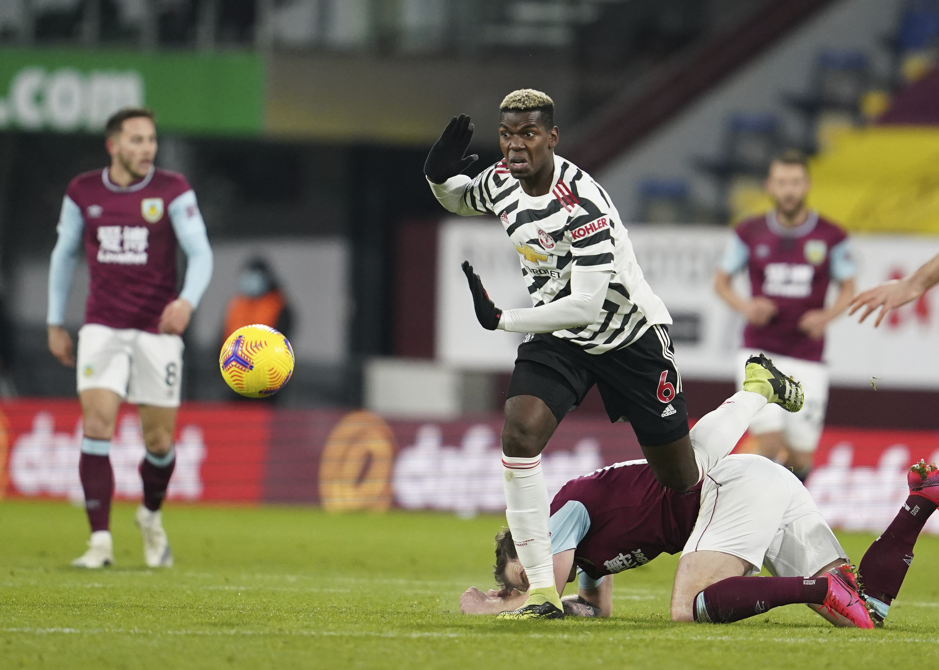 Manchester United's Paul Pogba, center, controls the ball during the English Premier League soccer match between Burnley and Manchester United in Burnley, England, Tuesday, Jan. 12, 2021. Manchester won the match 1-0. (AP Photo/Jon Super, Pool)