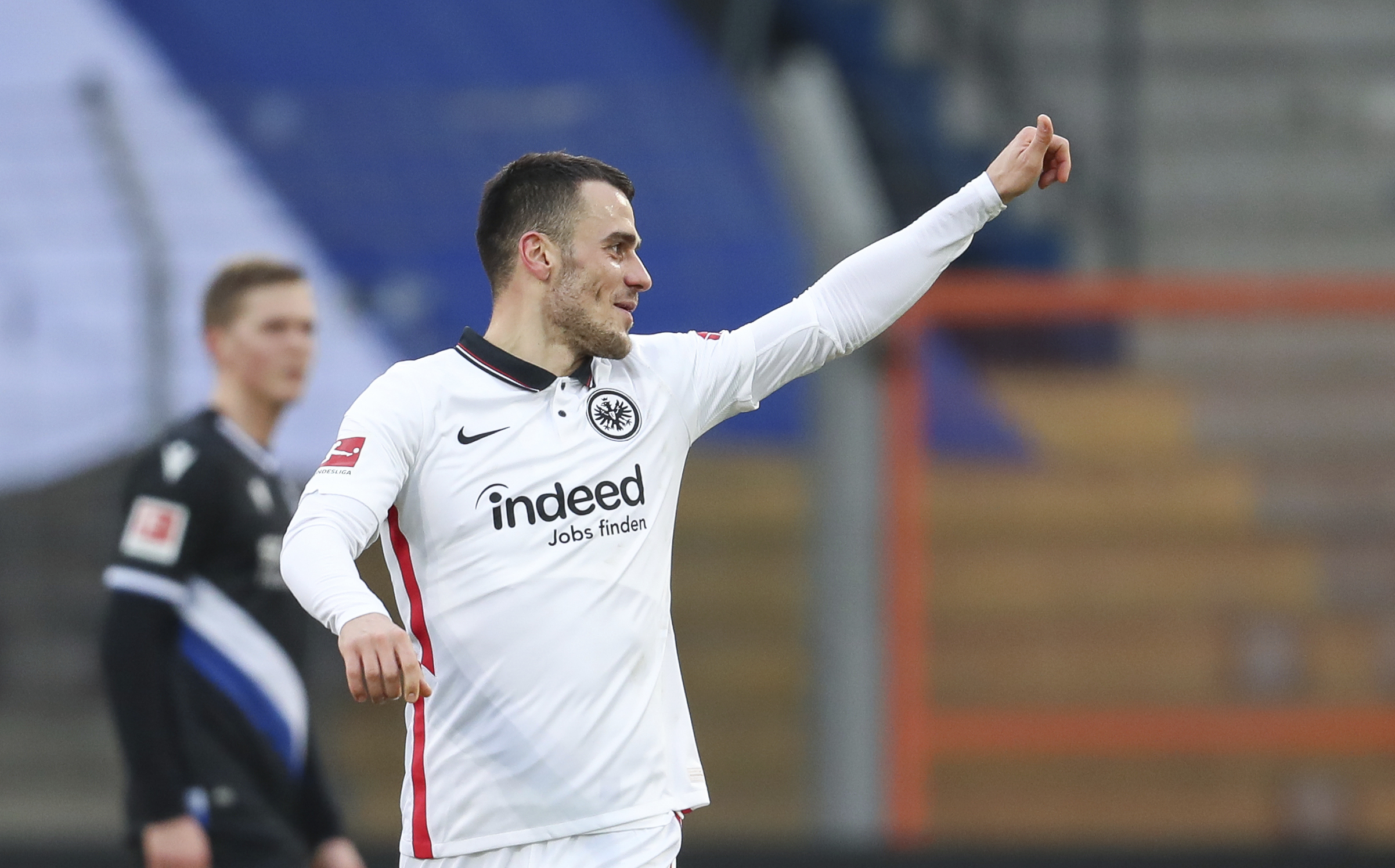 Frankfurt's Filip Kostic celebrates his side second goal during the German Bundesliga soccer match between Arminia Bielefeld and Eintracht Frankfurt in Bielefeld, Germany. Saturday, jan. 23, 2021. (Friso Gentsch/dpa via AP)