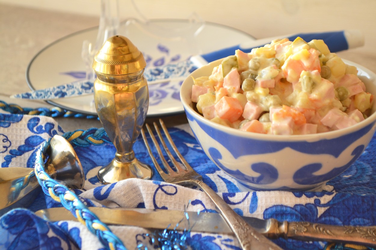 Winter traditional salad Olivier with boiled vegetables. Gzhel style.