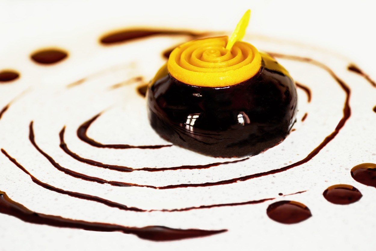 Shiny chocolate half sphere dessert with fruit spirale on table dripped with chocolate.,Image: 348815050, License: Rights-managed, Restrictions: , Model Release: no, Credit line: Hana Bartošová / Česká ilustrační fotografie / Profimedia