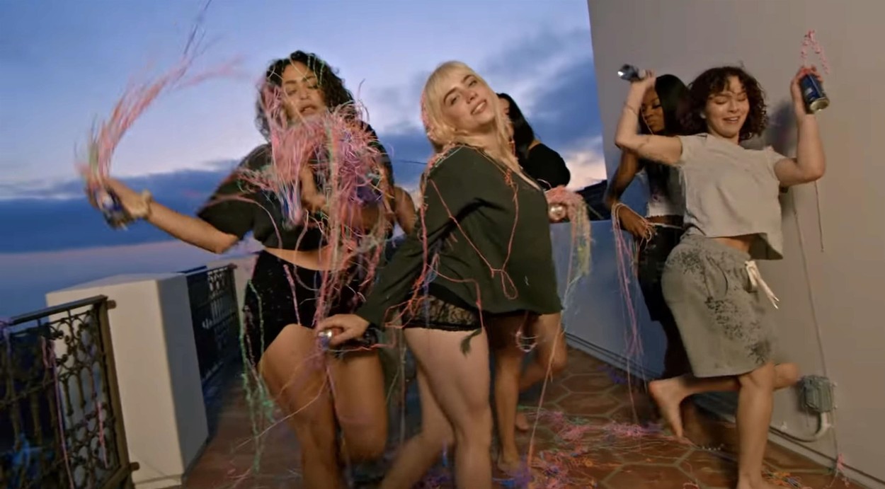 Billie Eilish shows off her stunning figure as she cavorts in bed with her girlfriends in latest music video