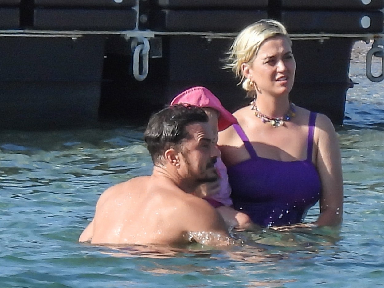 EXCLUSIVE: New Mom Katy Perry Wows In Purple Swimsuit As She Enjoys Greek Vacation With Husband Orlando Bloom And Baby Daughter Daisy Dove.