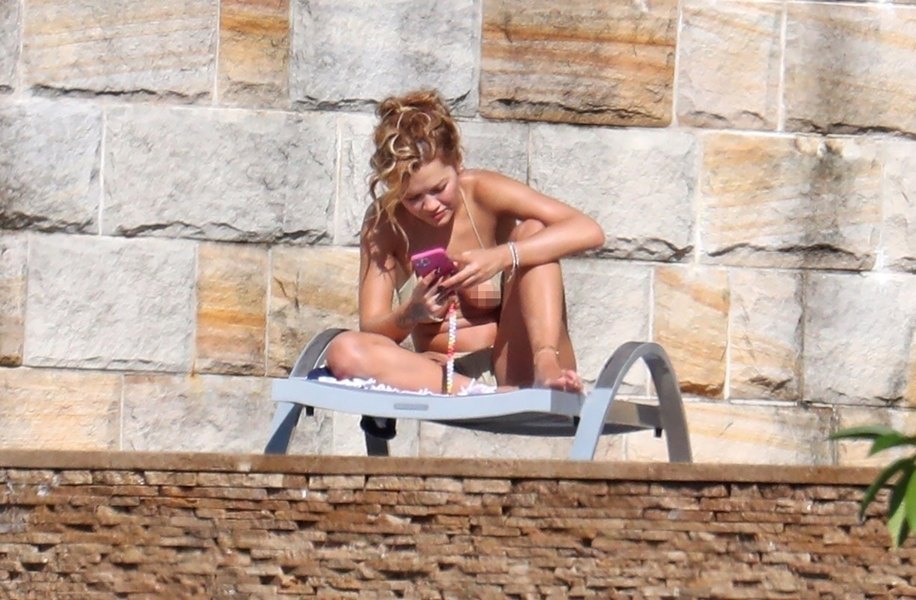 *EXCLUSIVE* Rita Ora has a wardrobe malfunction in her tiny green bikni while sunbathing in Sydney