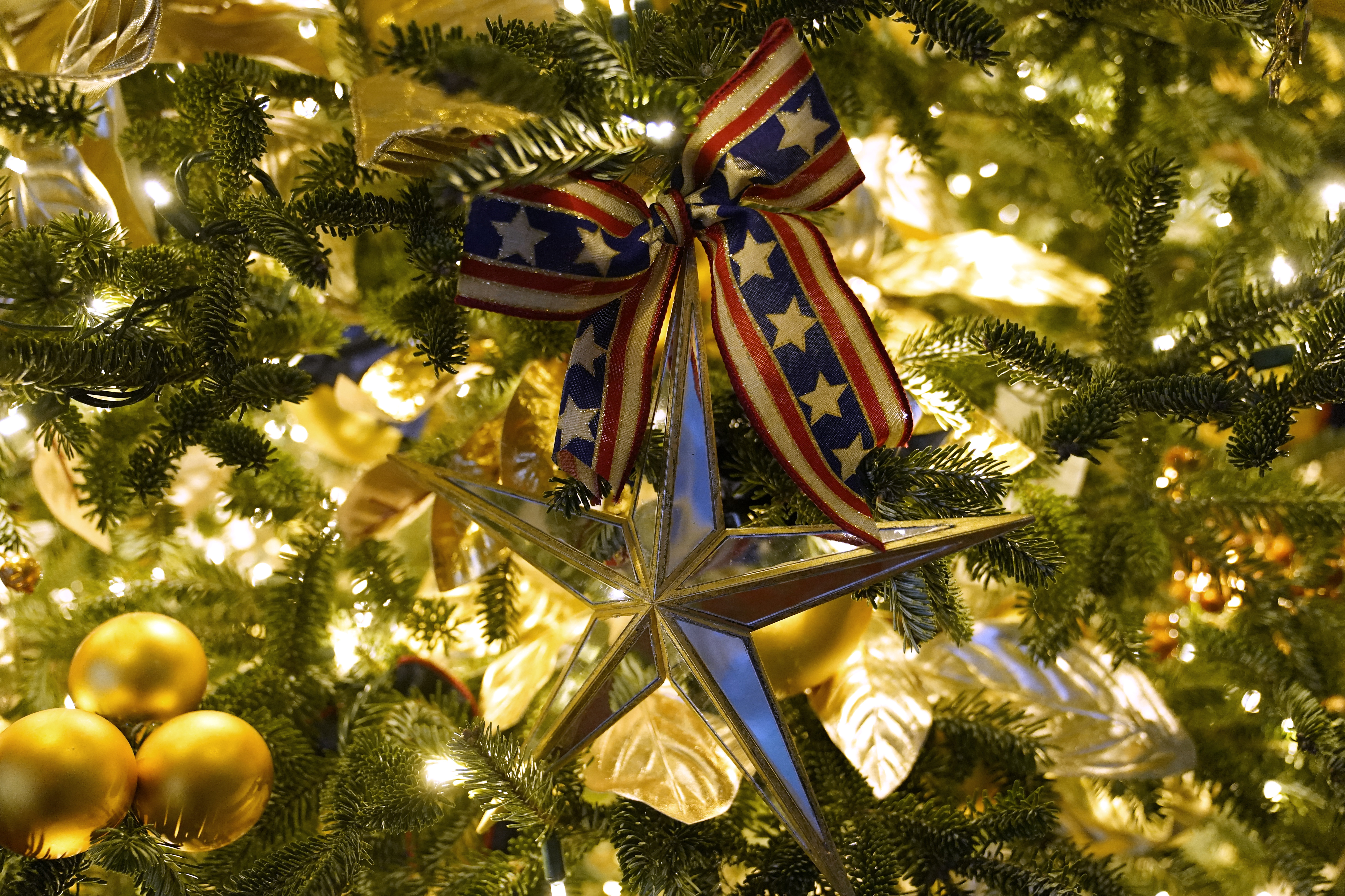 Ornaments hang from a tree during the 2020 Christmas preview at the White House, Monday, Nov. 30, 2020, in Washington. (AP Photo/Patrick Semansky)