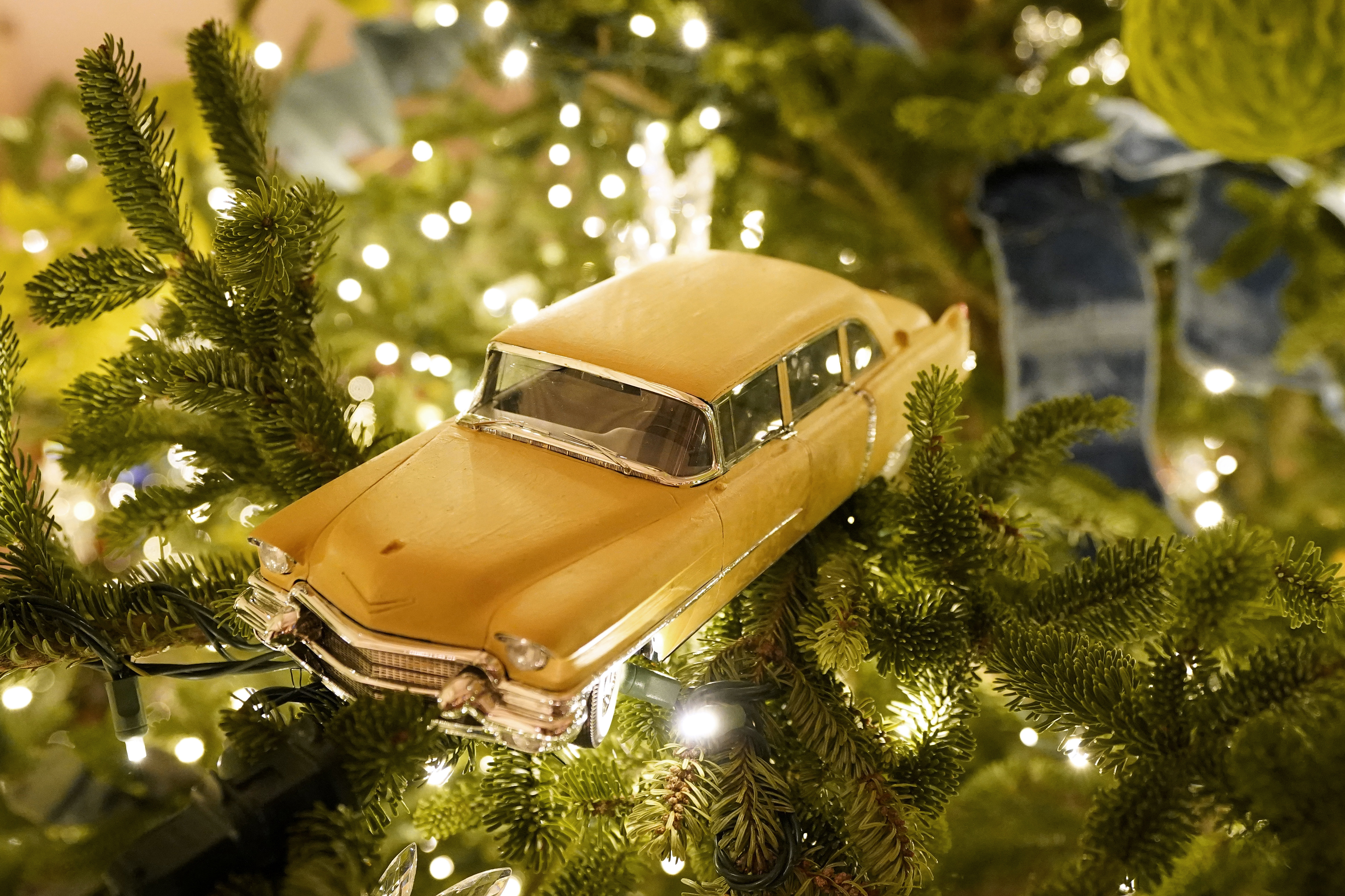 A toy car hangs in a Christmas tree in the East Room of the White House during the 2020 Christmas preview, Monday, Nov. 30, 2020, in Washington. (AP Photo/Patrick Semansky)