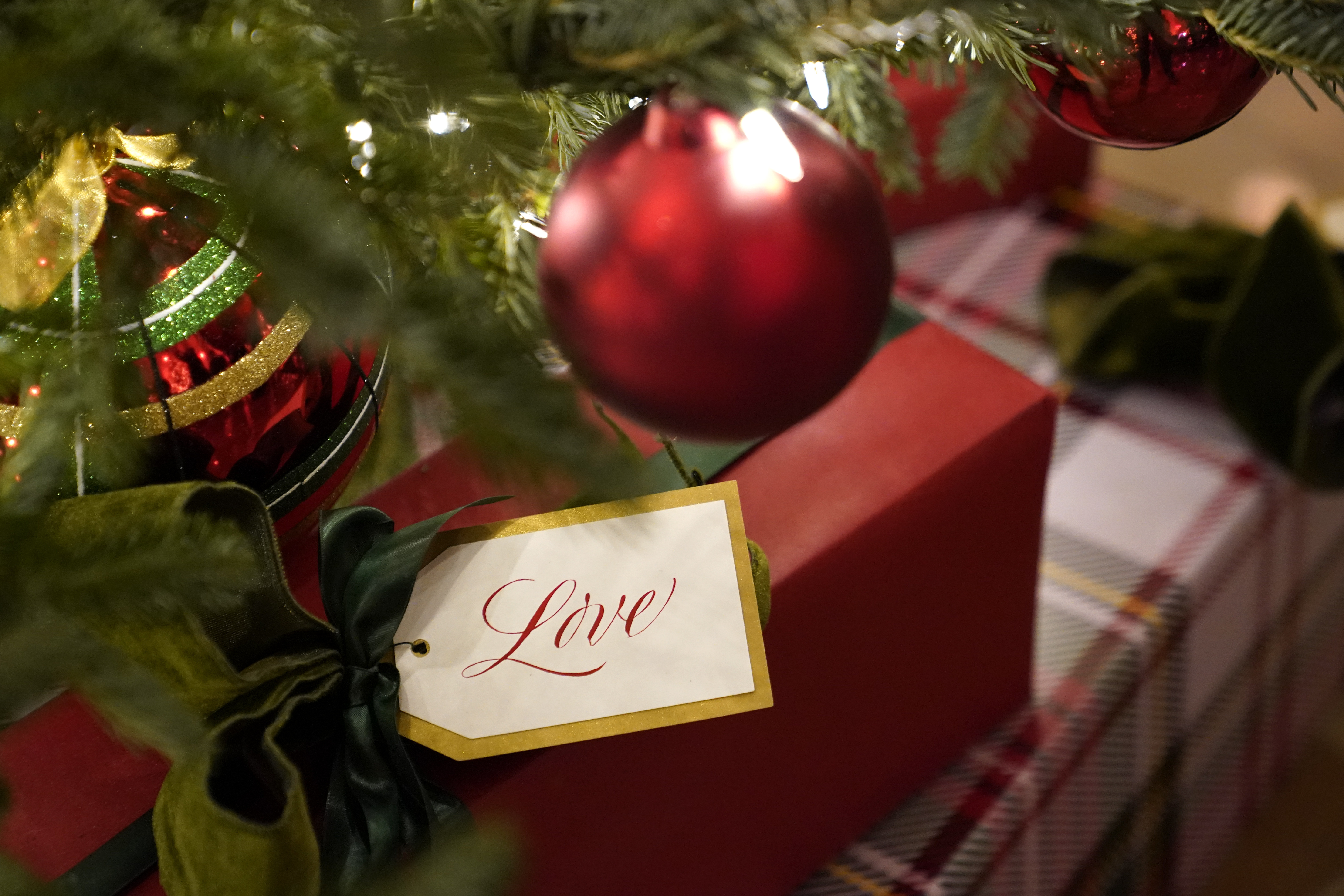 Decorations sit beneath a tree in Cross Hall during the 2020 Christmas preview at the White House, Monday, Nov. 30, 2020, in Washington. (AP Photo/Patrick Semansky)