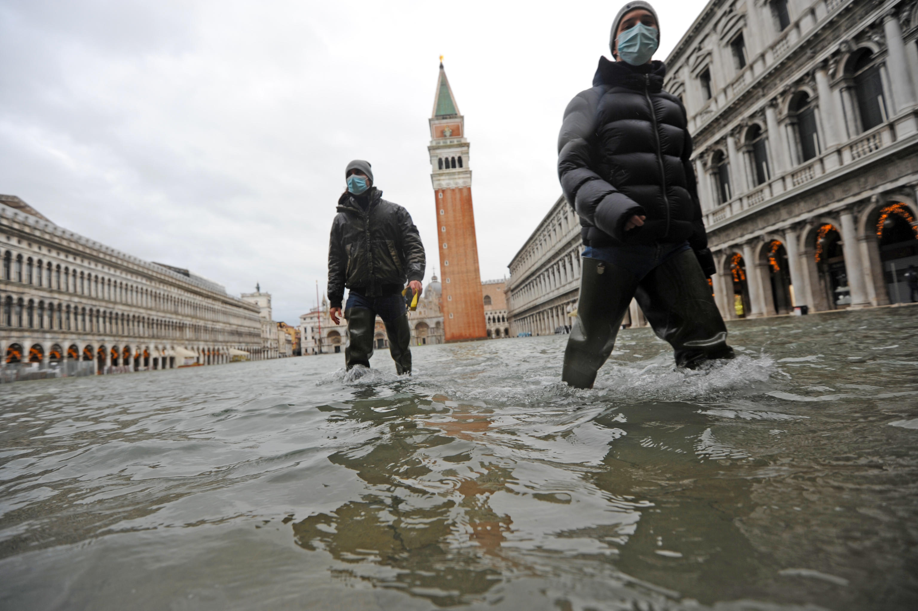 epa08870657 People wade through high water in Venice, Italy, 08 December 2020. A high water or Acqua alta phenomenon takes place in the winter in Venice.  EPA-EFE/ANDREA MEROLA