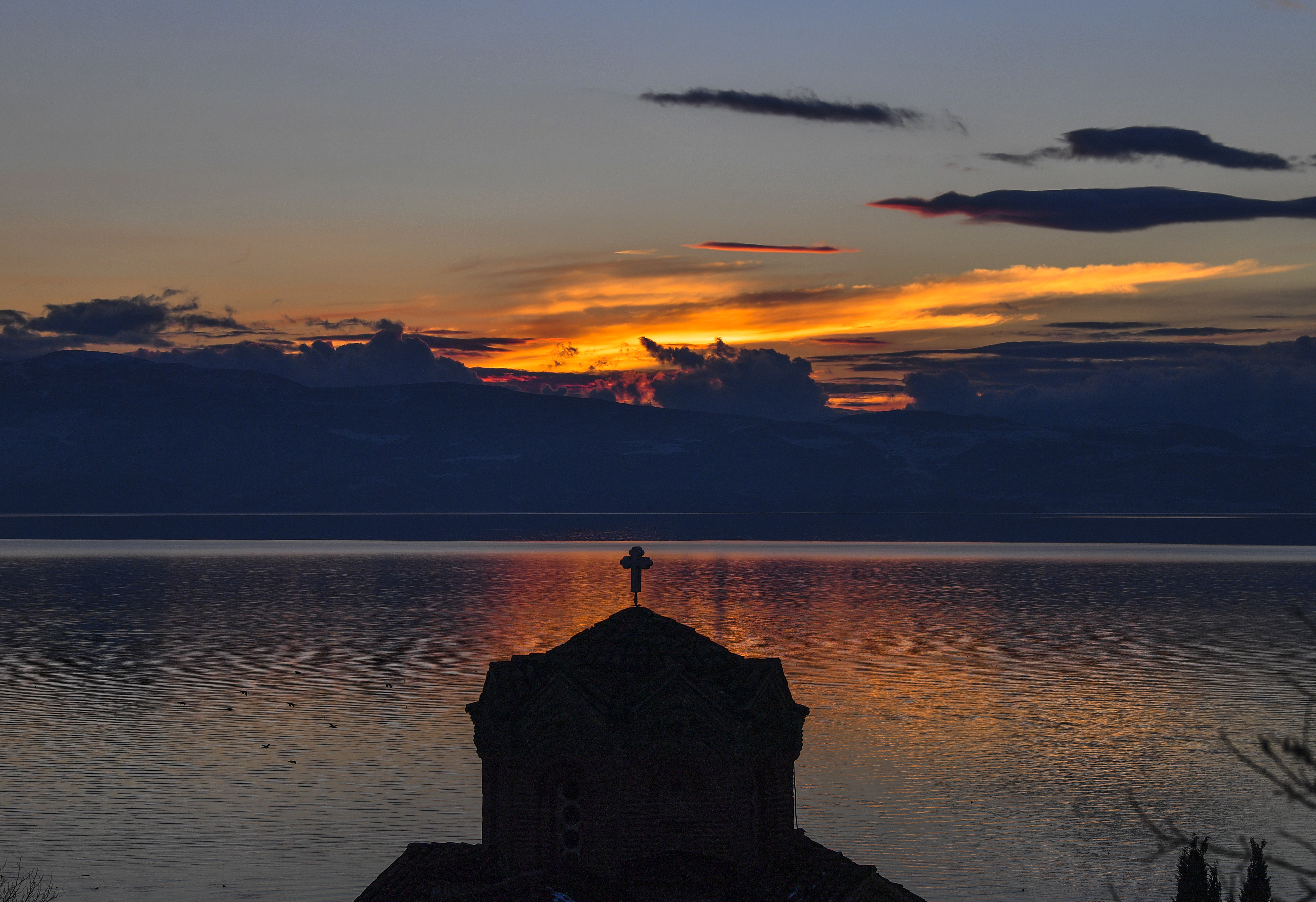 epa07304302 Sunset over orthodox church of St. John  at Kaneo above the Ohrid lake, The Former Yugoslav Republic of Macedonia, 20 January 2019.  EPA-EFE/GEORGI LICOVSKI