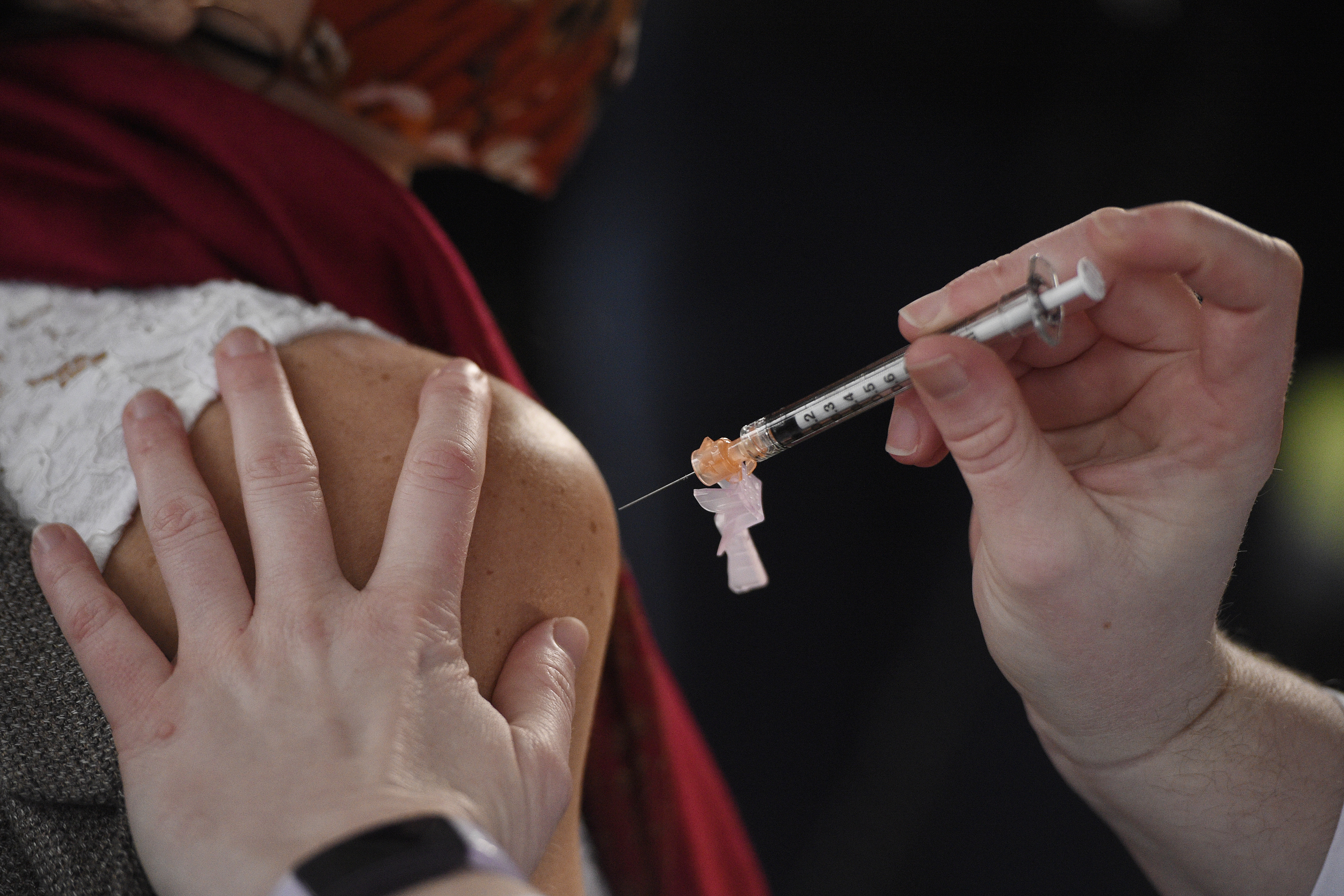System Pharmacy Clinical Manager at Hartford HealthCare Colleen Teevan administers the Pfizer-BioNTech vaccine for COVID-19 to a front line worker outside of Hartford Hospital, Monday, Dec. 14, 2020, in Hartford, Conn. (AP Photo/Jessica Hill)