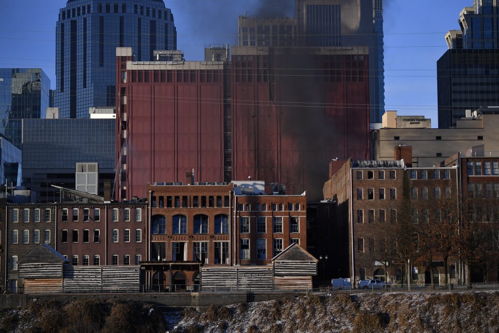 Smoke billows from the site of an explosion in the area on Friday, Dec. 25, 2020 in Nashville, Tenn. Buildings shook in the immediate area and beyond after a loud boom was heard early Christmas morning. (Andrew Nelles/The Tennessean via AP)