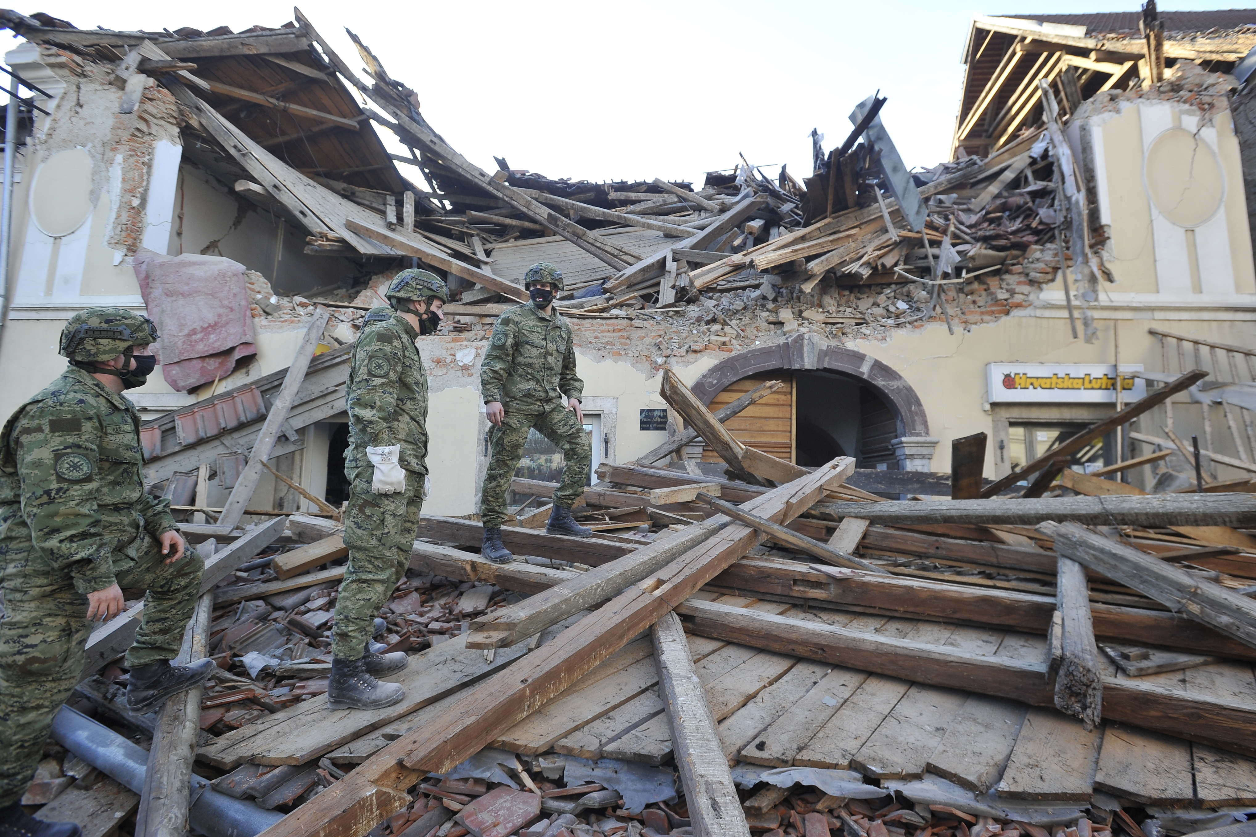 Soldiers inspect remains of a building damaged in an earthquake, in Petrinja, Croatia, Tuesday, Dec. 29, 2020. A strong earthquake has hit central Croatia and caused major damage and at least one death in a town southeast of the capital. (AP Photo)