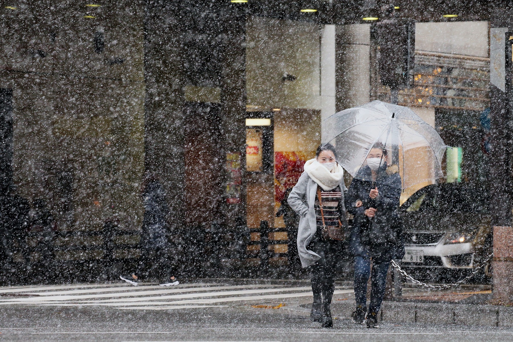 Pedestrians walk on a street as snow falls in Fukuoka on December 30, 2020.,Image: 579605071, License: Rights-managed, Restrictions: Japan OUT, Model Release: no, Credit line: STR / AFP / Profimedia