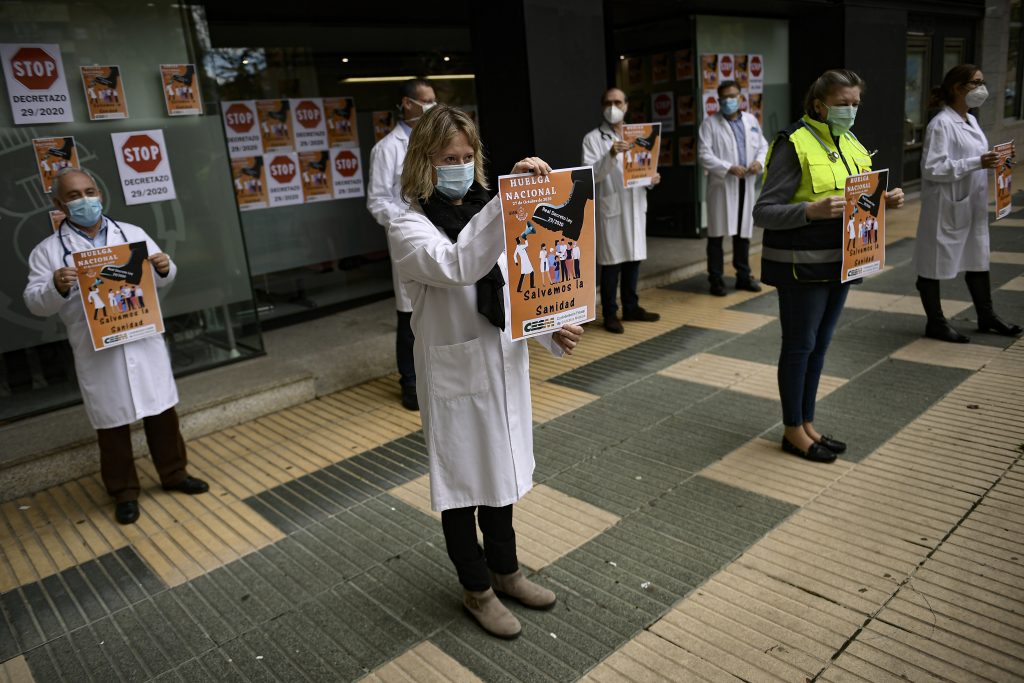Health service member calling for a general strike and demanding more labor protection on her job, in Pamplona, northern Spain, Tuesday, Oct. 27, 2020, while Spain suffer a second strong pandemic crisis by COVID-19.(AP Photo/Alvaro Barrientos)