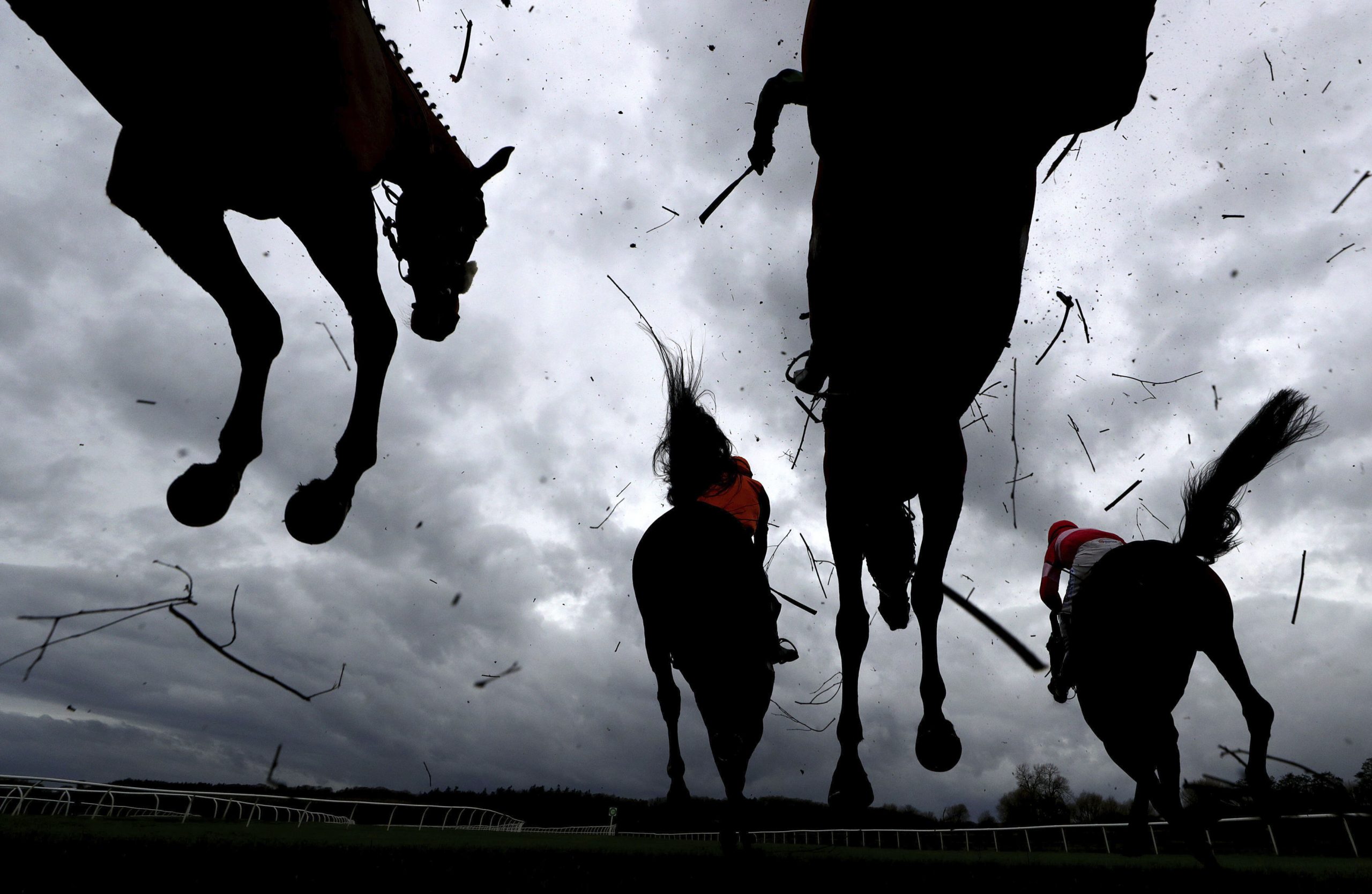 Runners and riders clear a fence during the Mares' Novices' Chase at Bangor Racecourse in Wrexham, Wales, Wednesday Nov. 11, 2020. (David Davies/PA via AP)