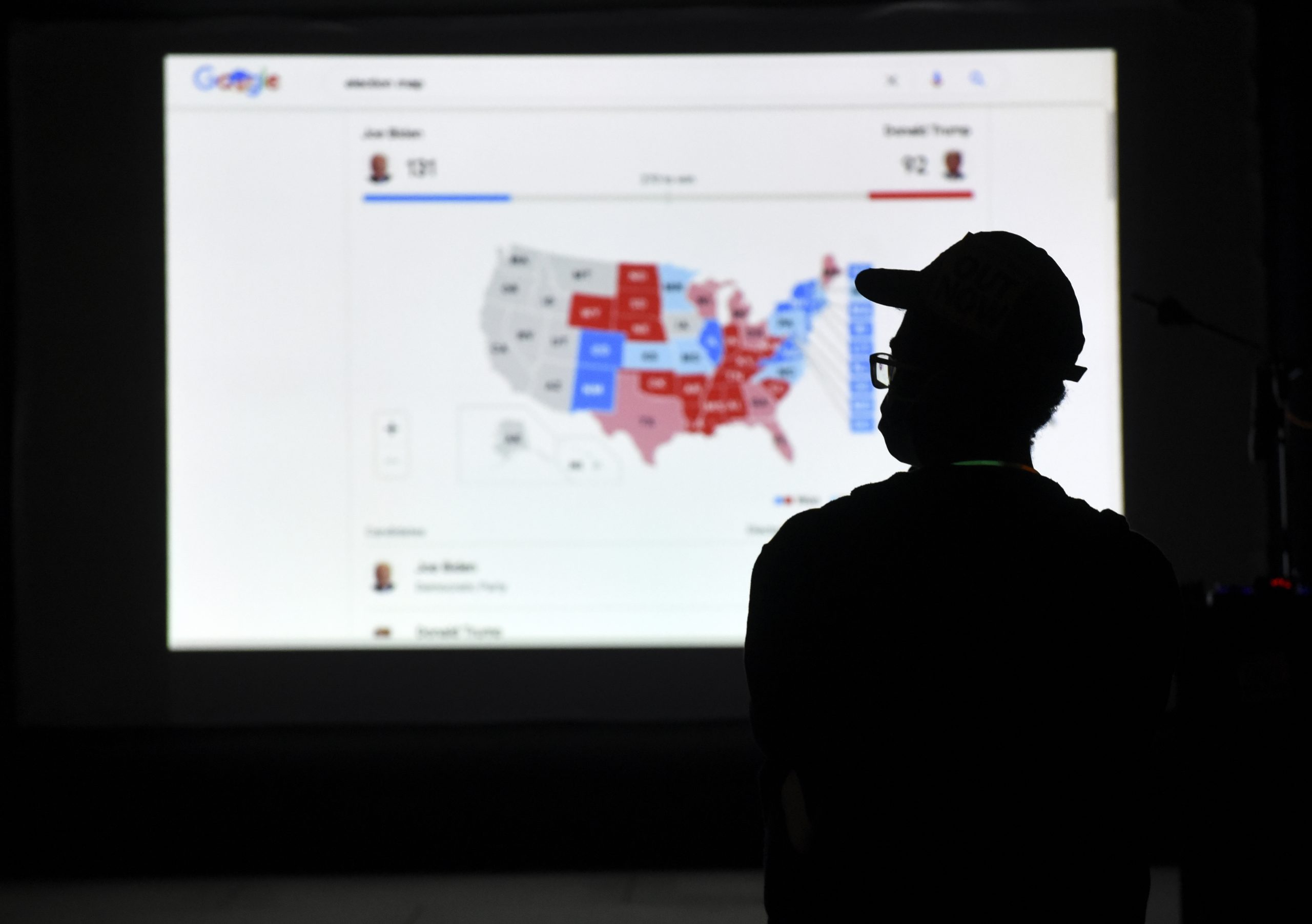A man watches results come in on a screen set up at an election night gathering at Independence Mall , Tuesday, Nov. 3, 2020, in Philadelphia. (AP Photo/Michael Perez)