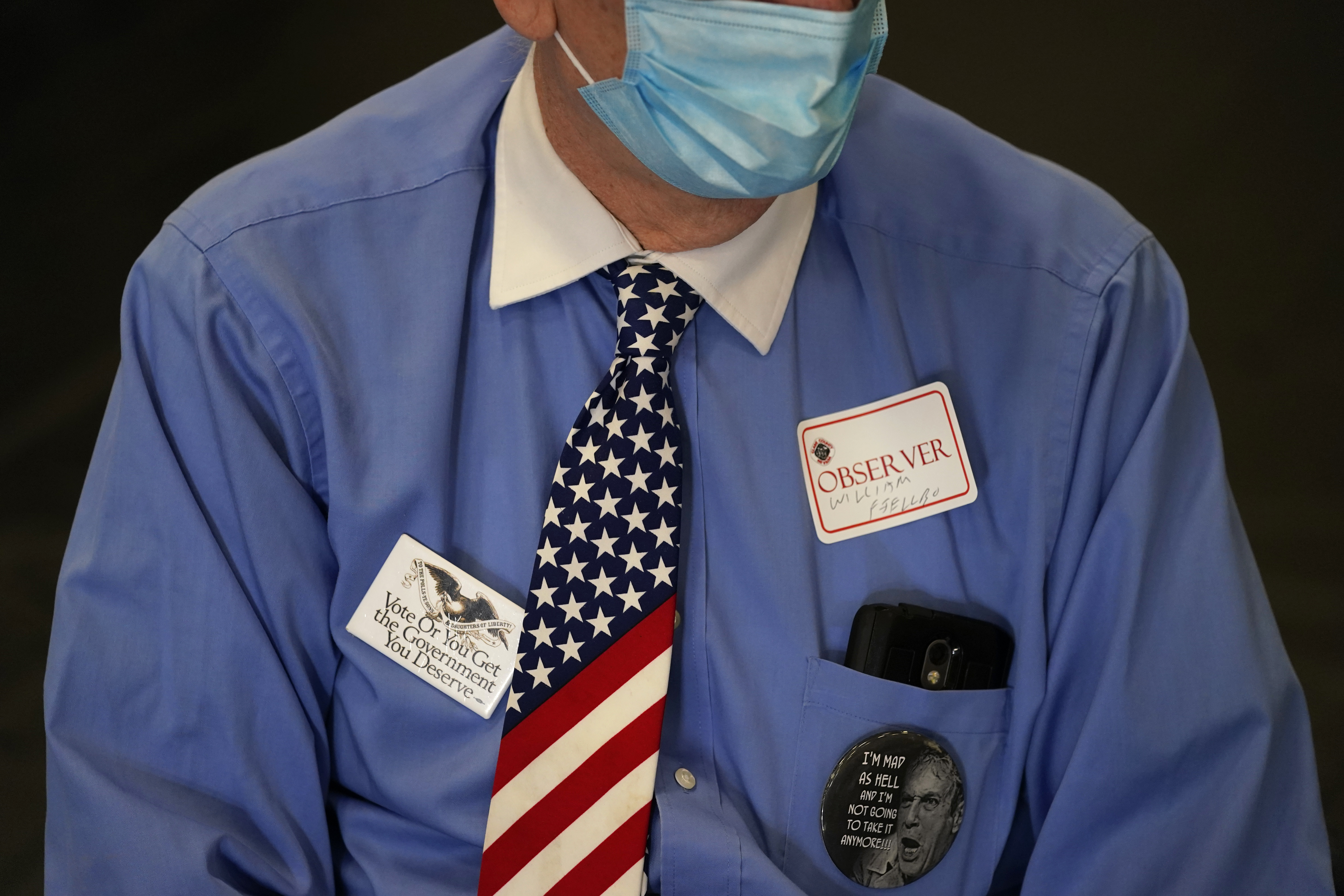 An observer watches a polling place on Election Day, Tuesday, Nov. 3, 2020, in Las Vegas. (AP Photo/John Locher)