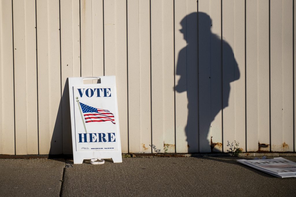 A voter walks toward the entrance of the Boys &amp; Girls Clubs of the Great Lakes Bay Region to cast their ballot in Bay City, Mich., during Election Day on Tuesday, Nov. 3, 2020. (Kaytie Boomer/The Bay City Times via AP)