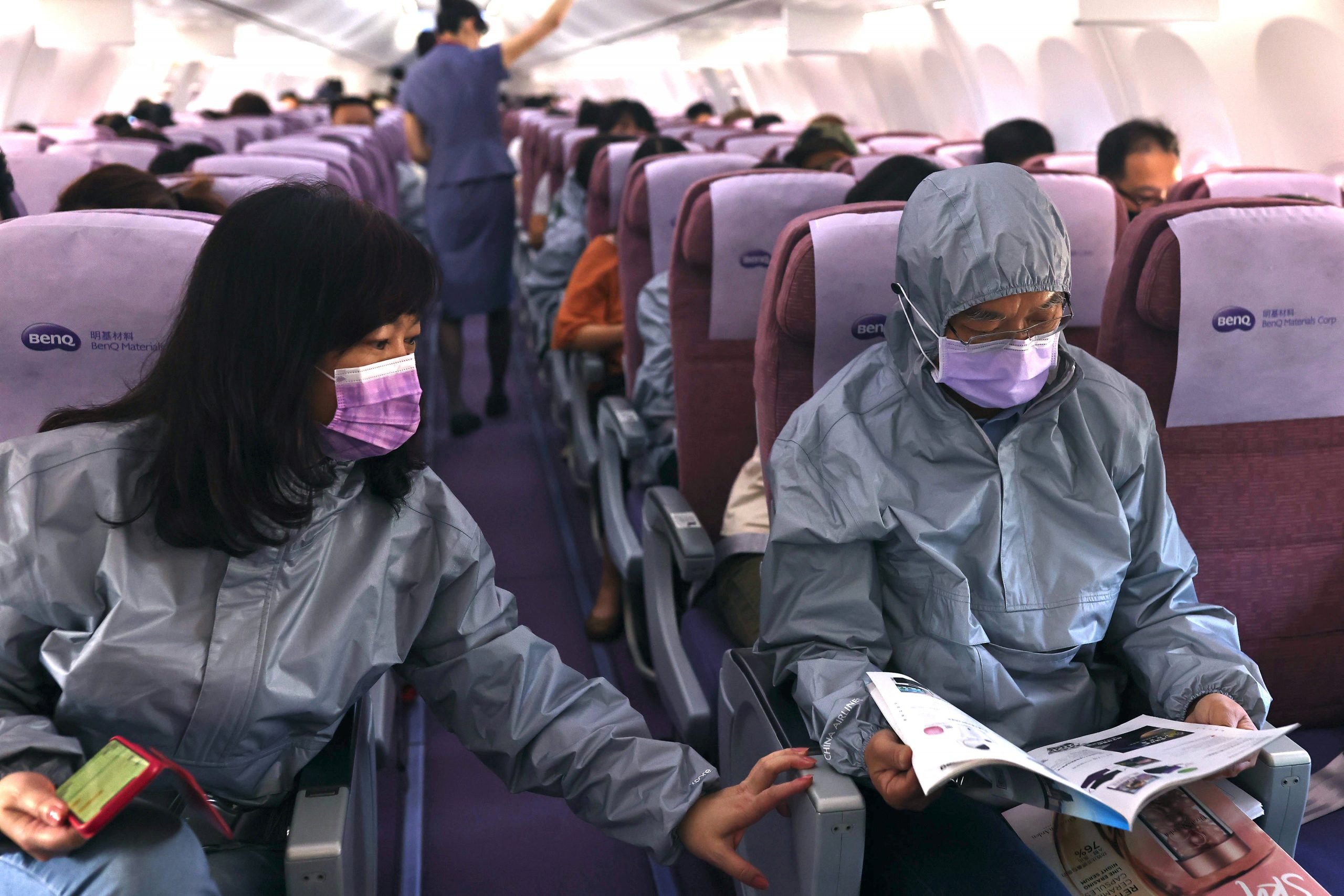Z.C. Chen, chairman of BenQ, reads the duty-free magazine while wearing a protective outfit on a flight, amid the spread of the coronavirus disease (COVID-19), in Taipei, Taiwan November 19, 2020. REUTERS/Ann Wang