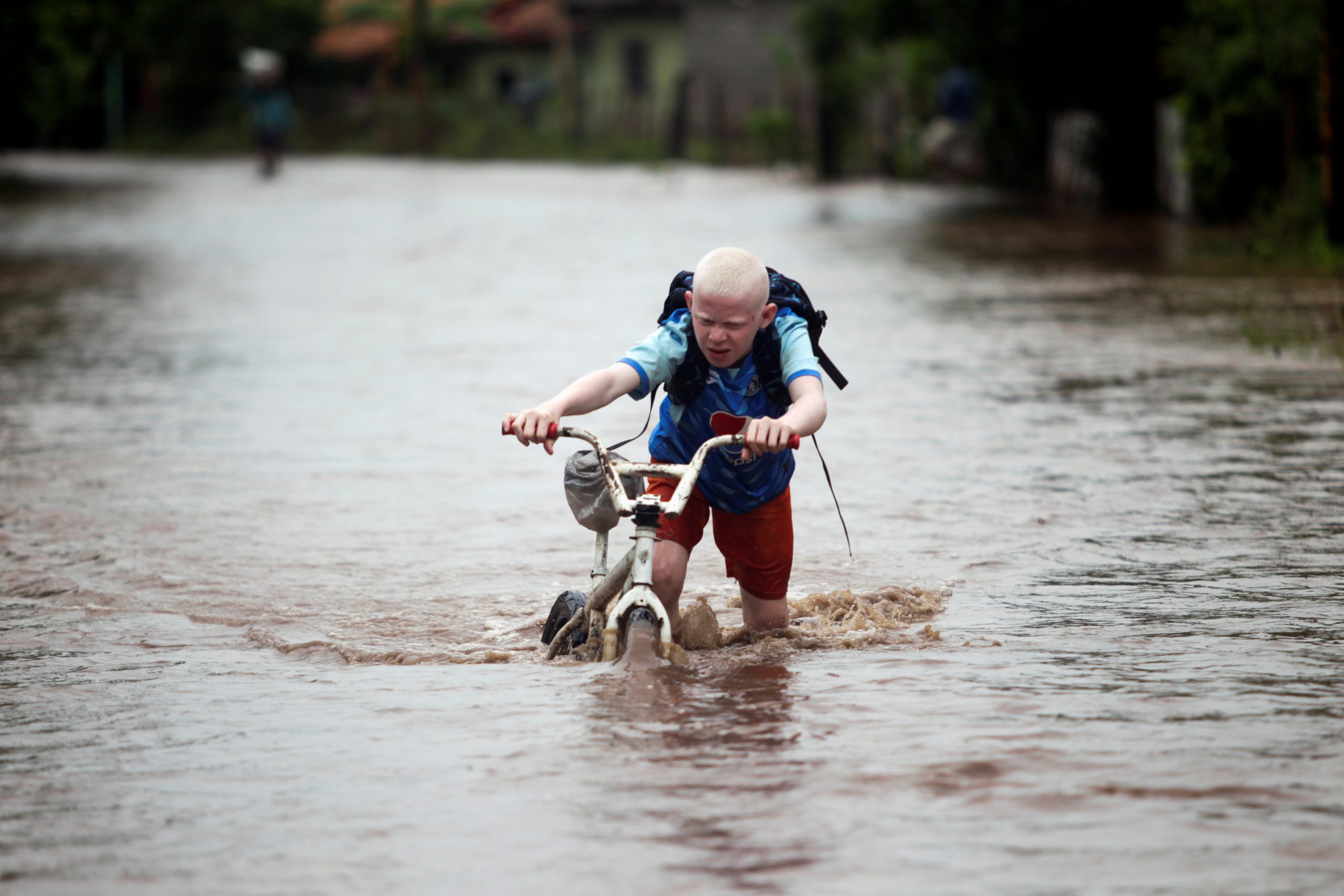 A child pushes his bicycle through a flooded road after the passing of Storm Iota, in Marcovia, Honduras November 18, 2020. REUTERS/Jorge Cabrera     TPX IMAGES OF THE DAY