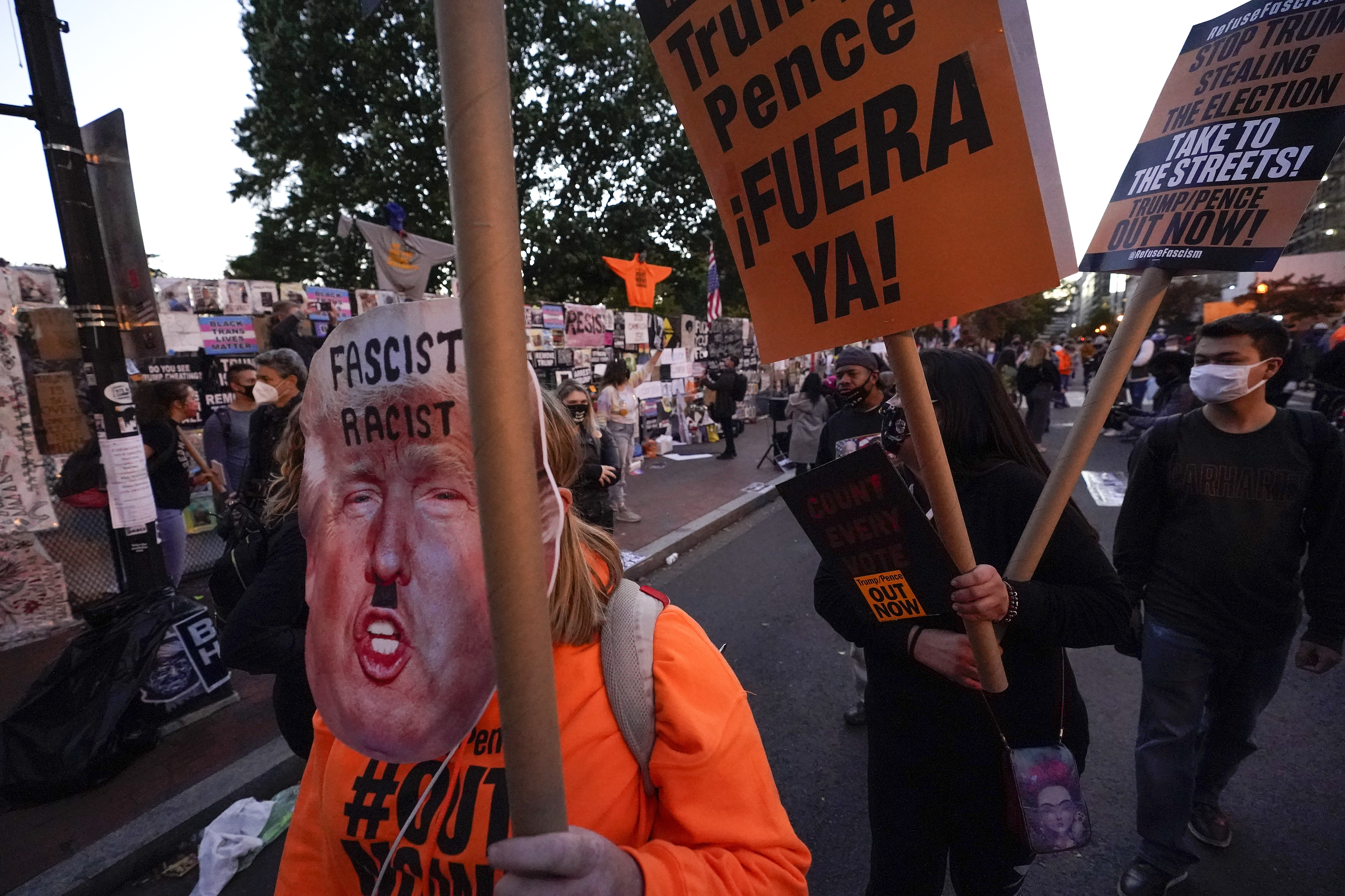 Demonstrators march through the streets outside the White House, Wednesday, Nov. 4, 2020, in Washington. (AP Photo/Alex Brandon)