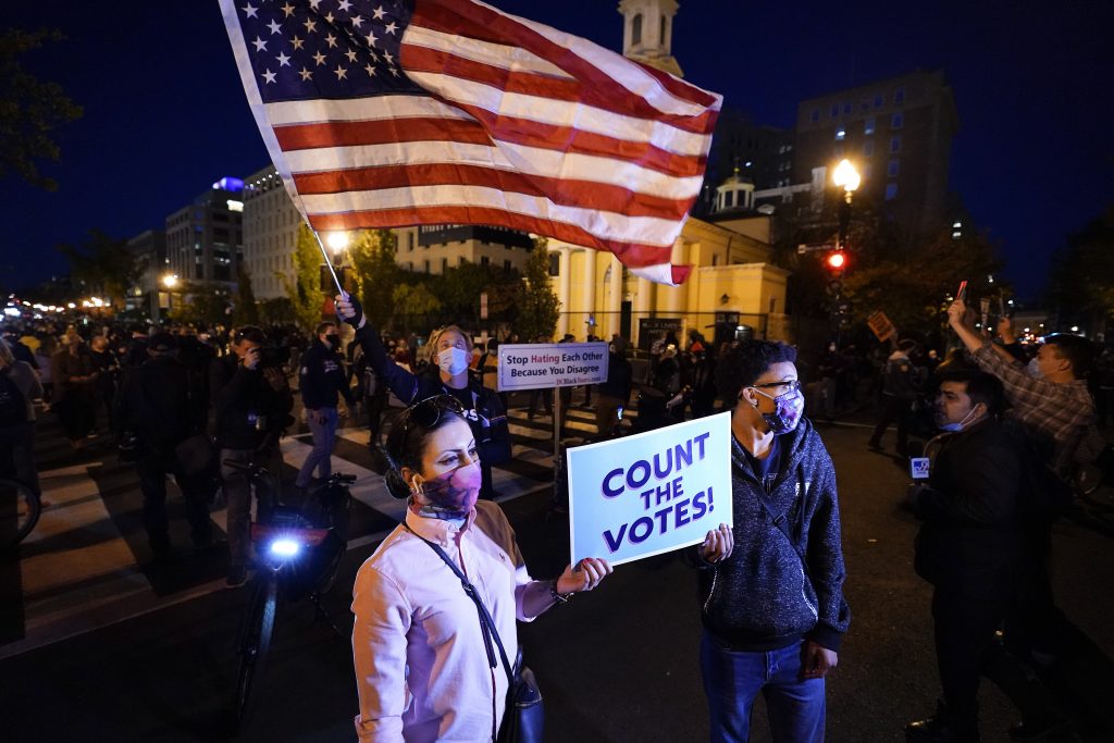 Demonstrators gather at Black Lives Matter Plaza to advocate that all votes be counted one day after Election Day, Wednesday, Nov. 4, 2020, in Washington. (AP Photo/Alex Brandon)