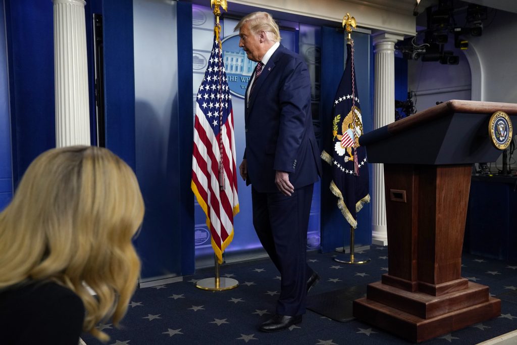 President Donald Trump leaves after speaking at the White House, Thursday, Nov. 5, 2020, in Washington. At left iOS White House press secretary Kayleigh McEnany. (AP Photo/Evan Vucci)