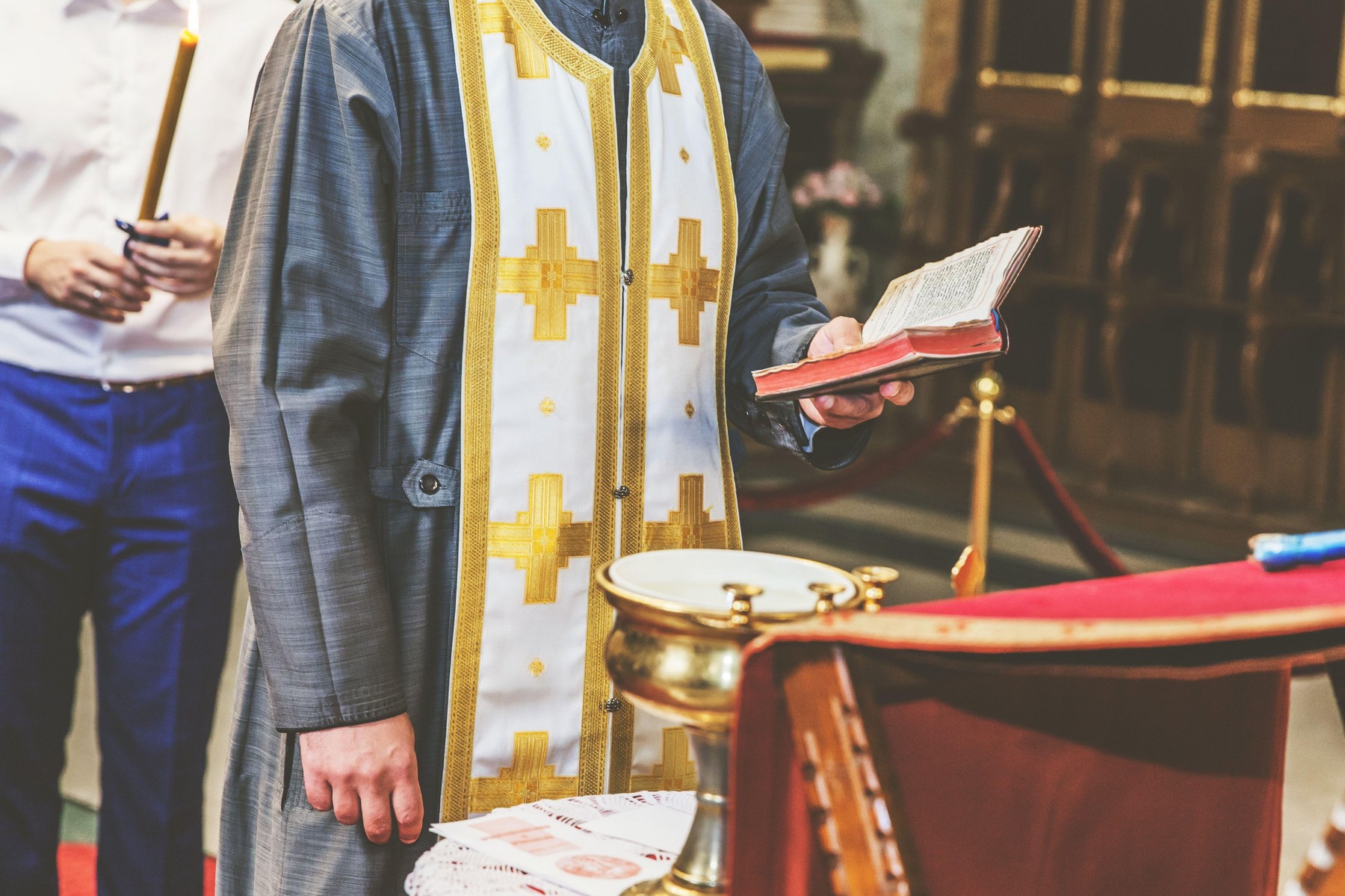 orthodox priest holds a golden cross in an orthodox church during a religious ceremony