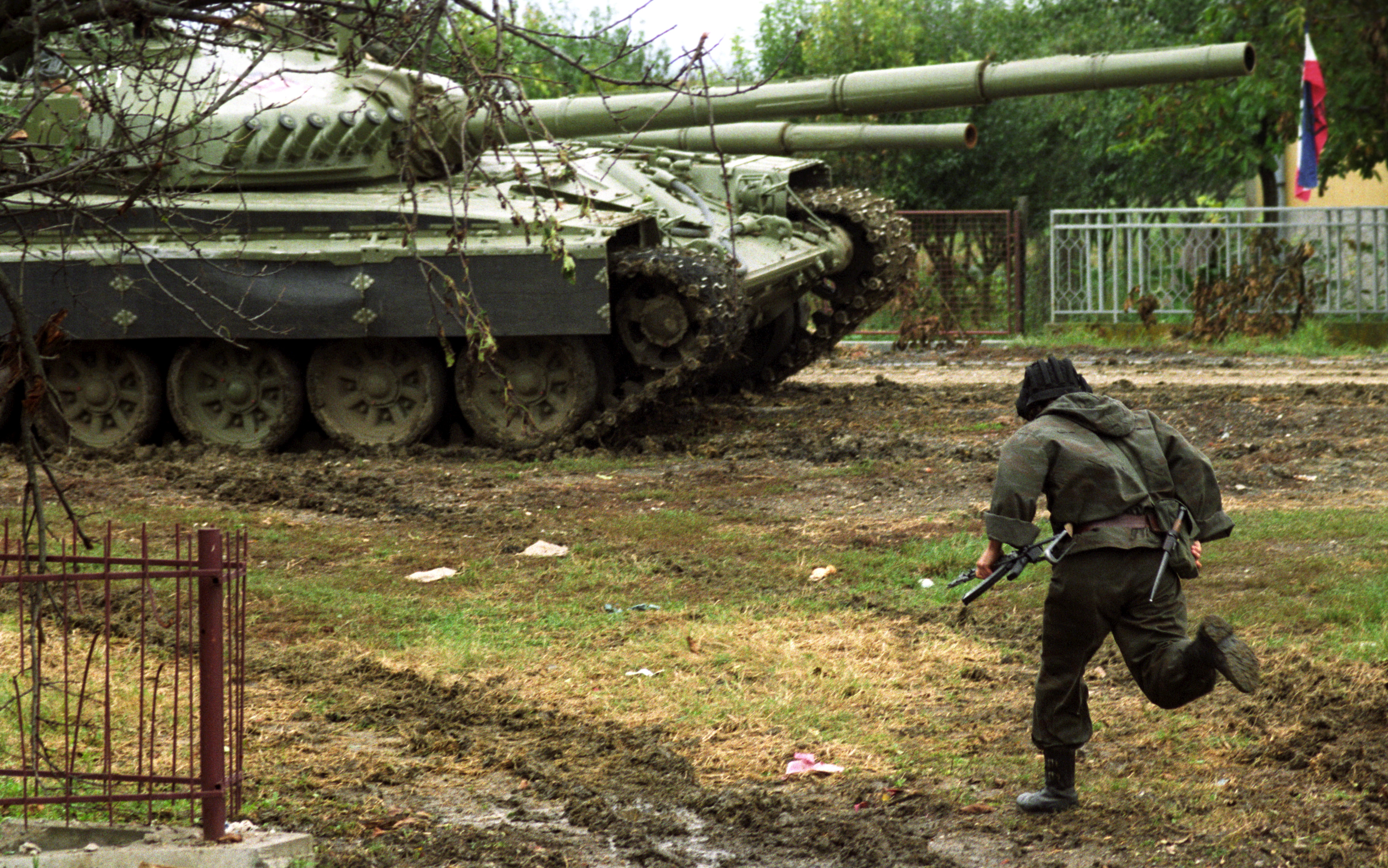 Yugoslav army soldier runs towards the tank during the shelling by the Croat forces, Vukovar, Croatia, Yugoslavia, 02 October 1991. EPA/MAJA ILIC