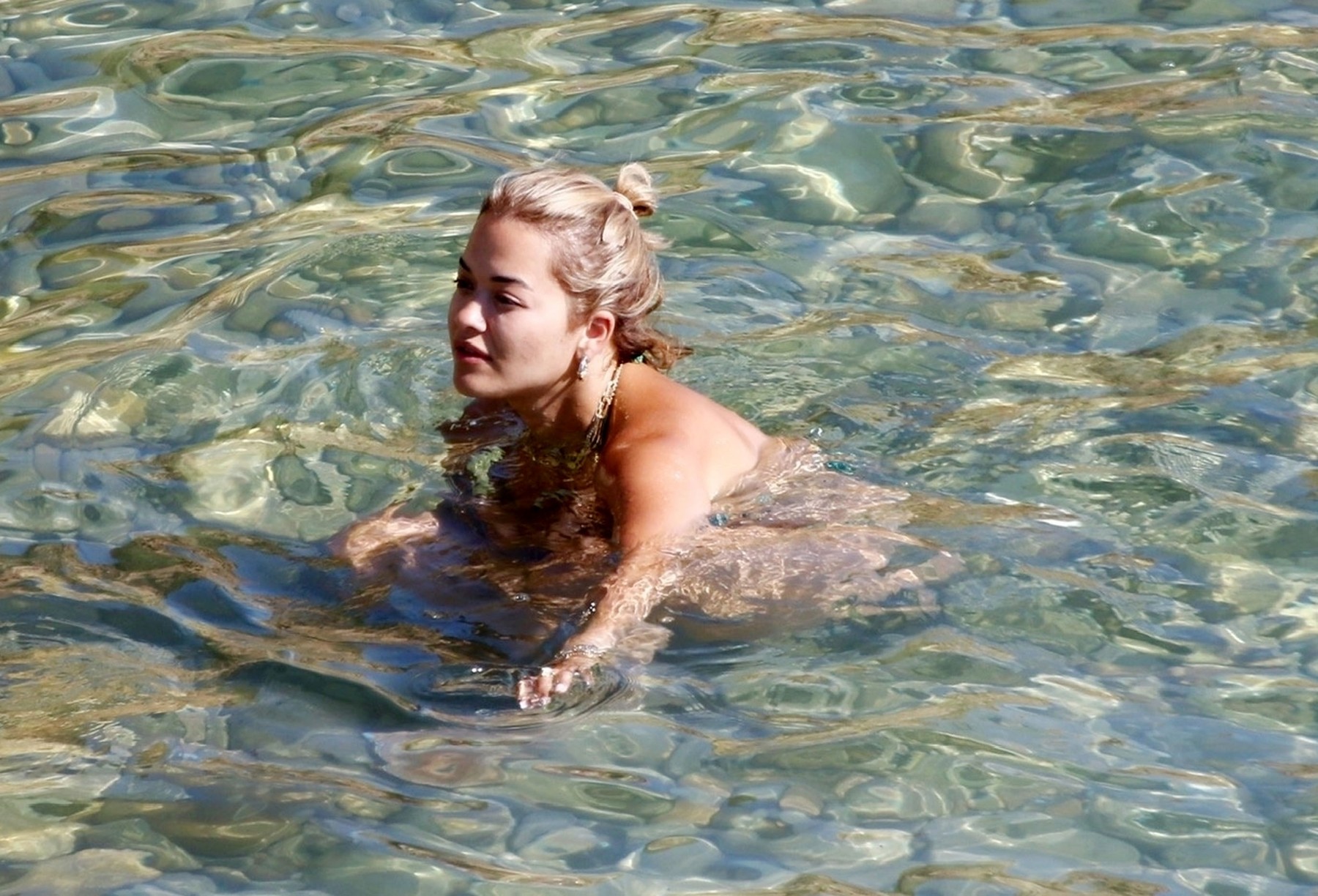 Singer Rita Ora pictured with friends enjoying a refreshing dip in the sea while on her summer holiday in Ibiza.