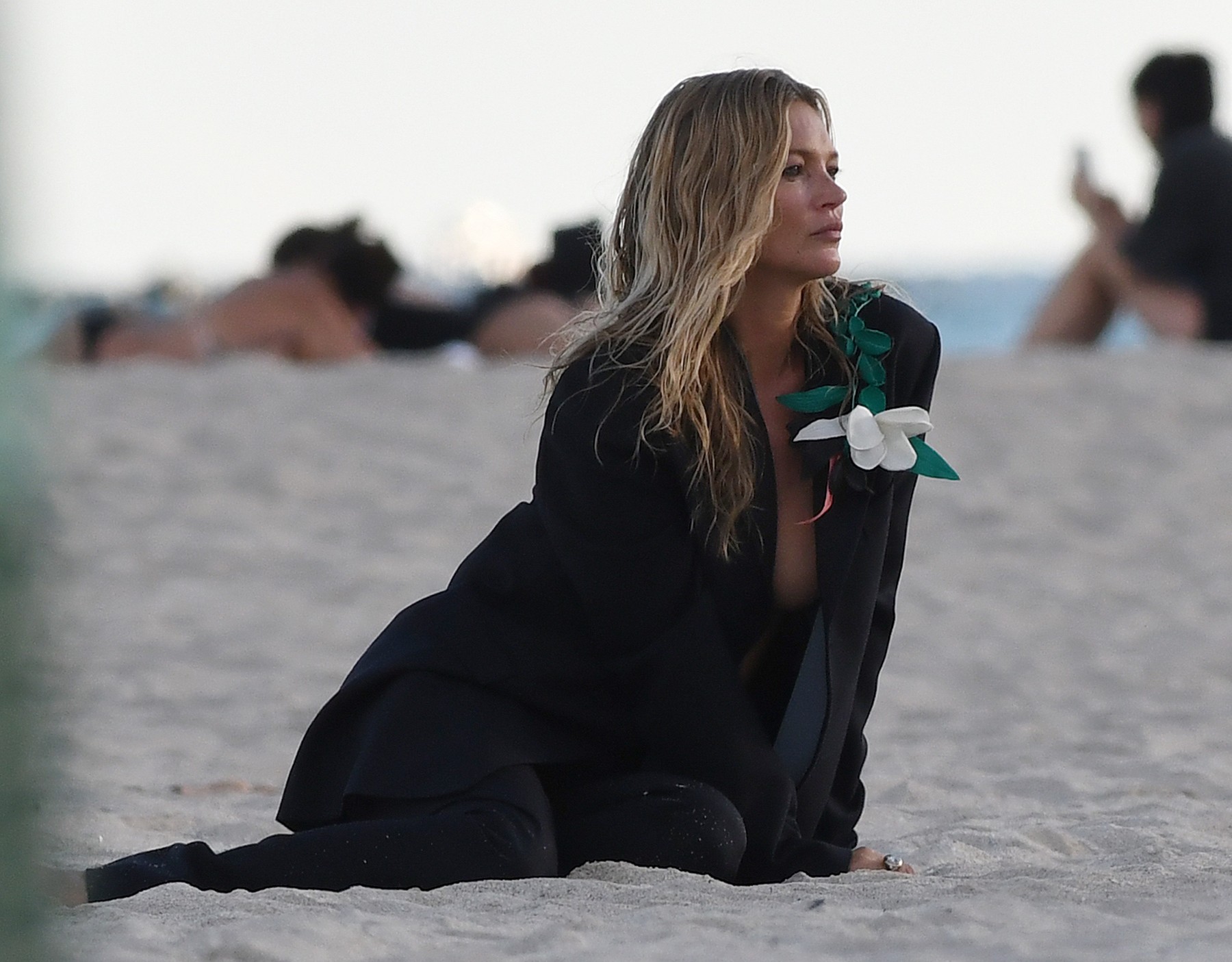 PREMIUM EXCLUSIVE: *NO WEB UNTIL 1700 EST 8TH DEC* Supermodel Kate Moss goes completely topless under a trench coat during a photoshoot on the beach in Miami