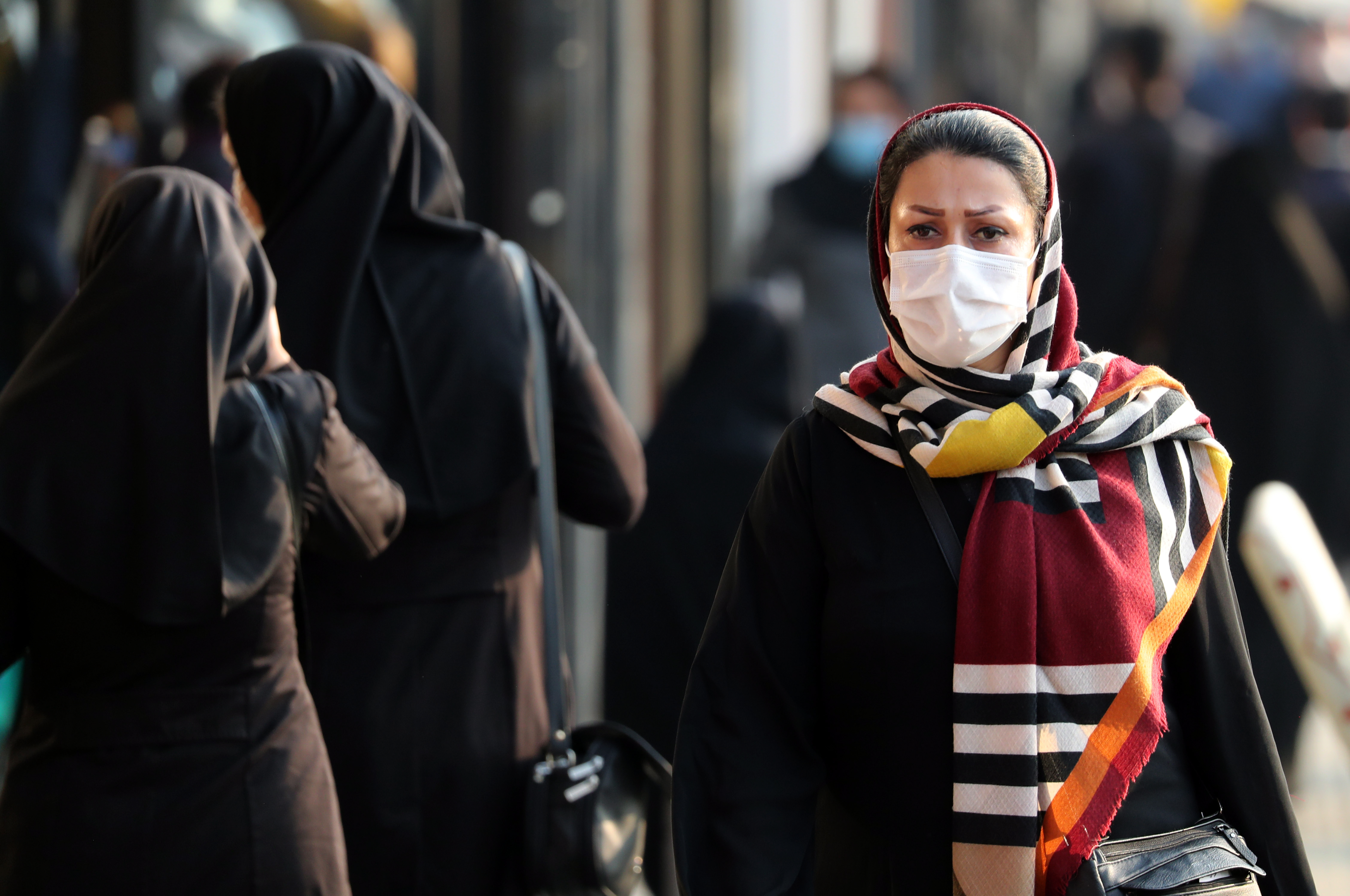 epa08734275 An Iranian woman wearing a face mask walks in a street in Tehran, Iran, 10 October 2020. Iranian President Hassan Rouhani announced on 10 October that wearing face masks is mandatory in the capital Tehran.  EPA-EFE/ABEDIN TAHERKENAREH