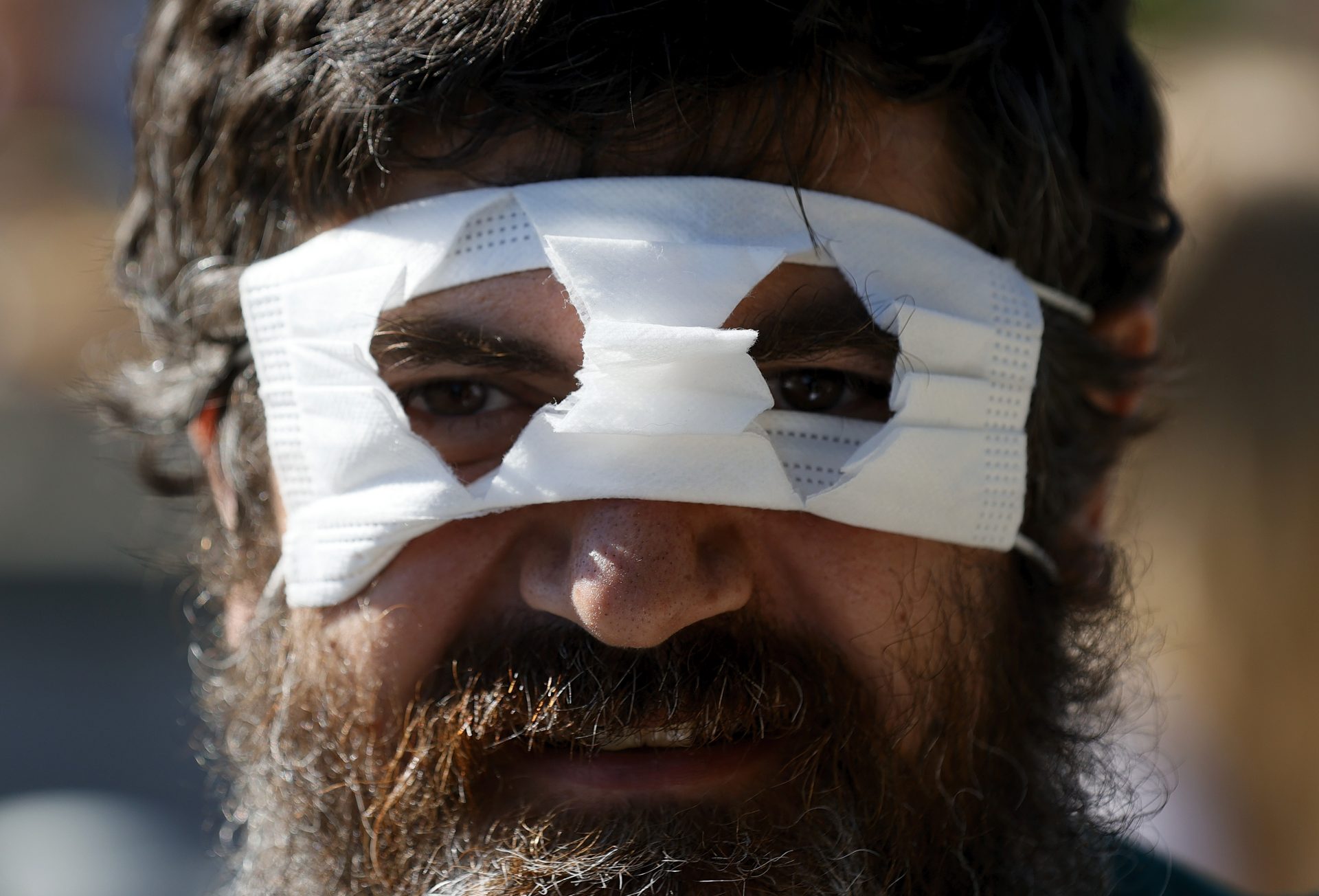 epa08719713 A protester wears a face mask at Lake Constance in Konstanz, Germany, 04 October 2020. Various demonstrations and rallies against and in favor of coronavirus restrictions will take place on 03 and 04 October in Konstanz.  EPA-EFE/RONALD WITTEK