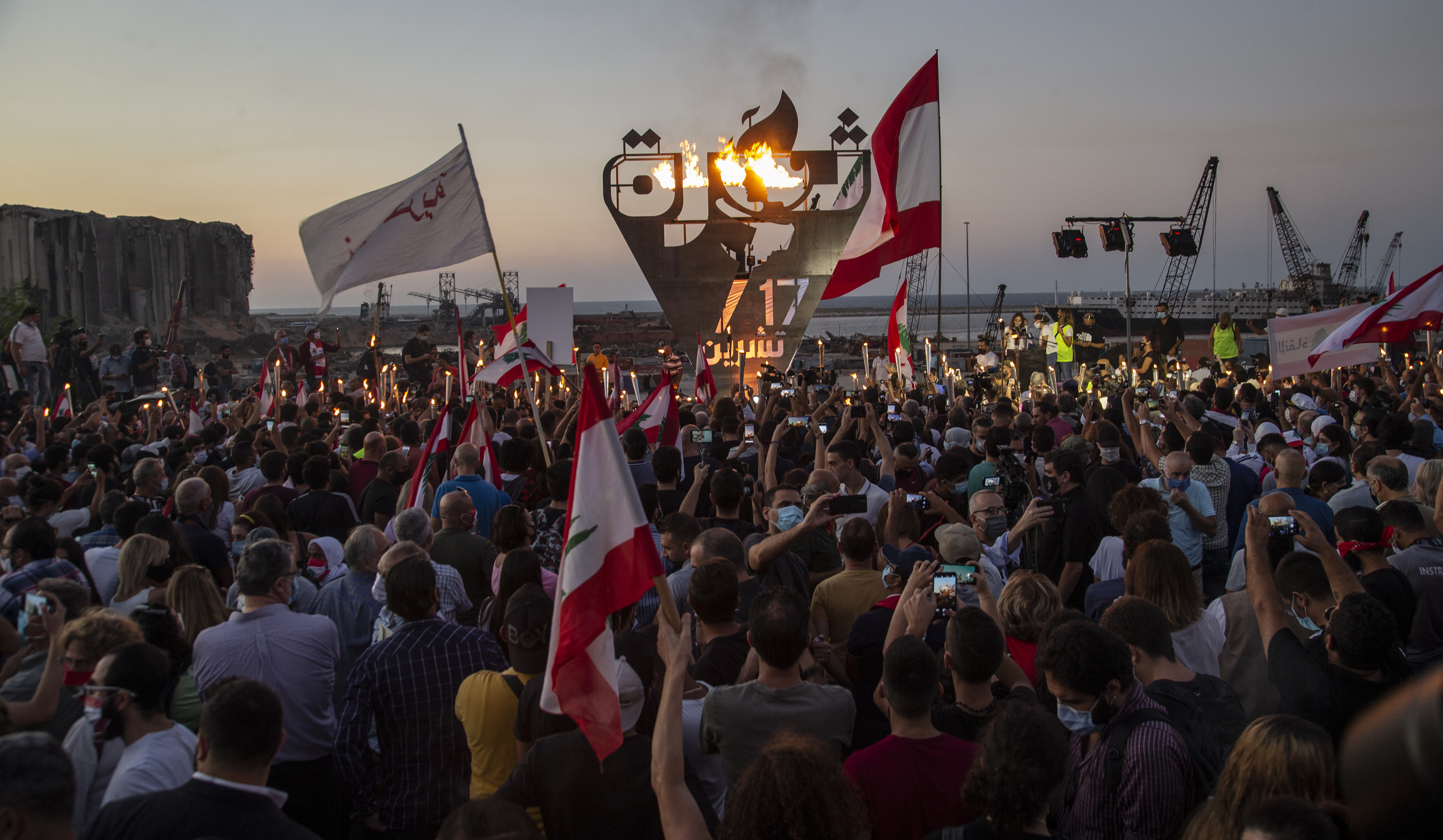 Anti-government protesters march in Beirut to mark the first anniversary of protest movement