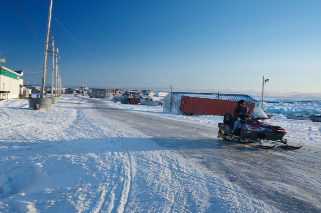 Snowmobile or skidoo Inuit and child on the main road in Igloolik or Iglulik village, Nunavut northern Canada October 2006,Image: 7599736, License: Rights-managed, Restrictions: , Model Release: no, Credit line: louise murray / Alamy / Alamy / Profimedia