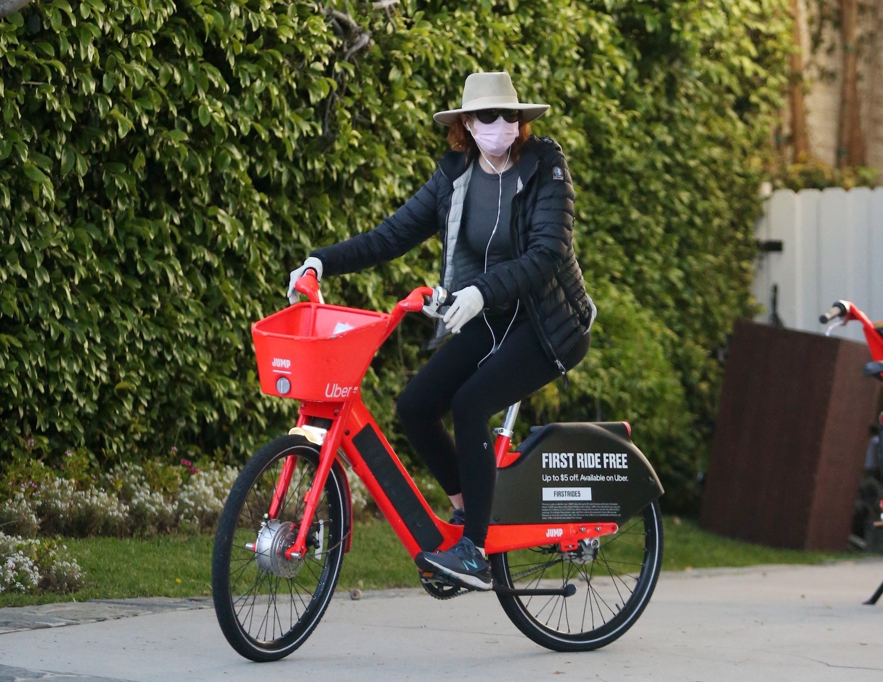 Santa Monica, CA  - *EXCLUSIVE*  - Marcia Cross unlocks a public Uber Jump rental electric bike with her phone app and then goes out for a ride wearing protective mask and gloves, listening to music during the COVID-19 safer at home order.