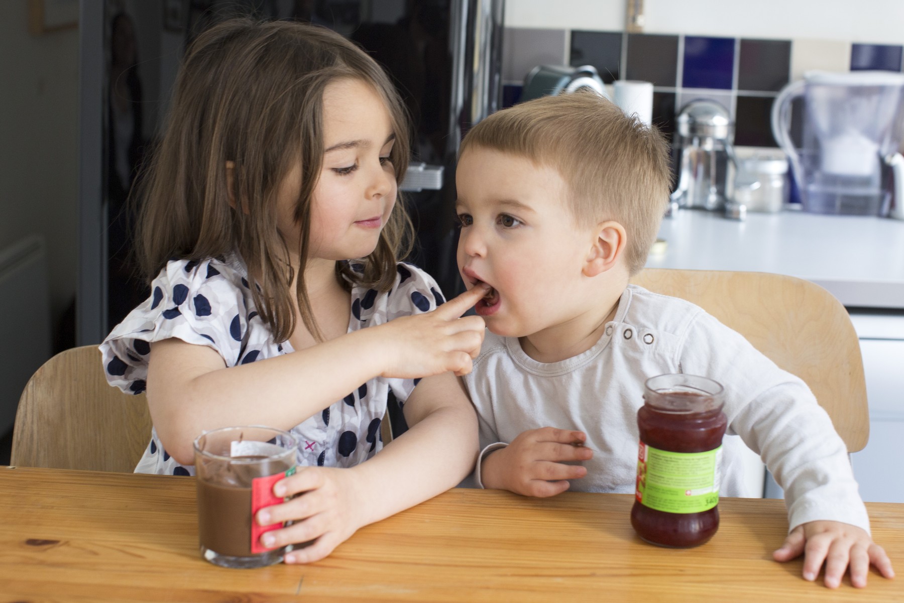 Young siblings tasting contents of jars with their fingers,Image: 295672709, License: Royalty-free, Restrictions: , Model Release: yes, Credit line: - / PhotoAlto / Profimedia