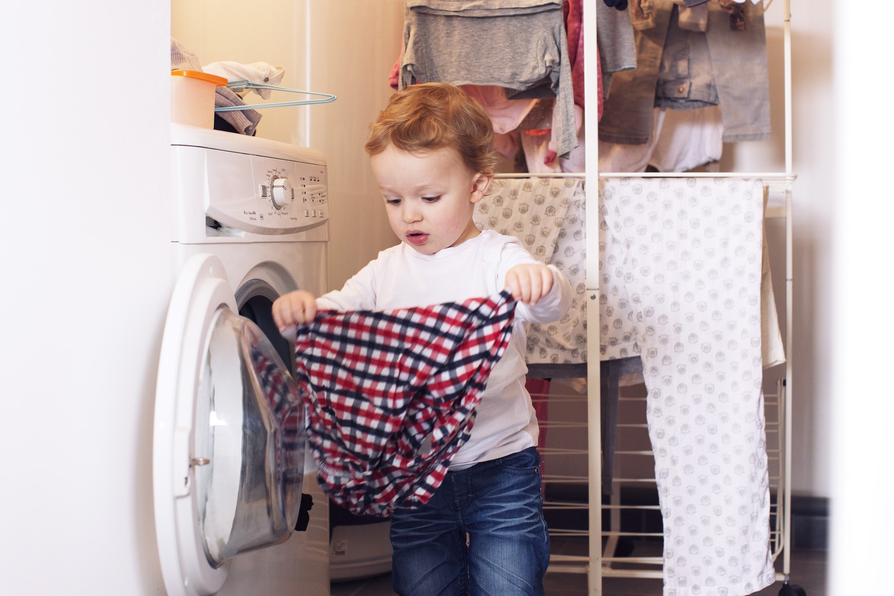 Little boy taking clothes out of dryer,Image: 295709510, License: Royalty-free, Restrictions: , Model Release: yes, Credit line: - / PhotoAlto / Profimedia