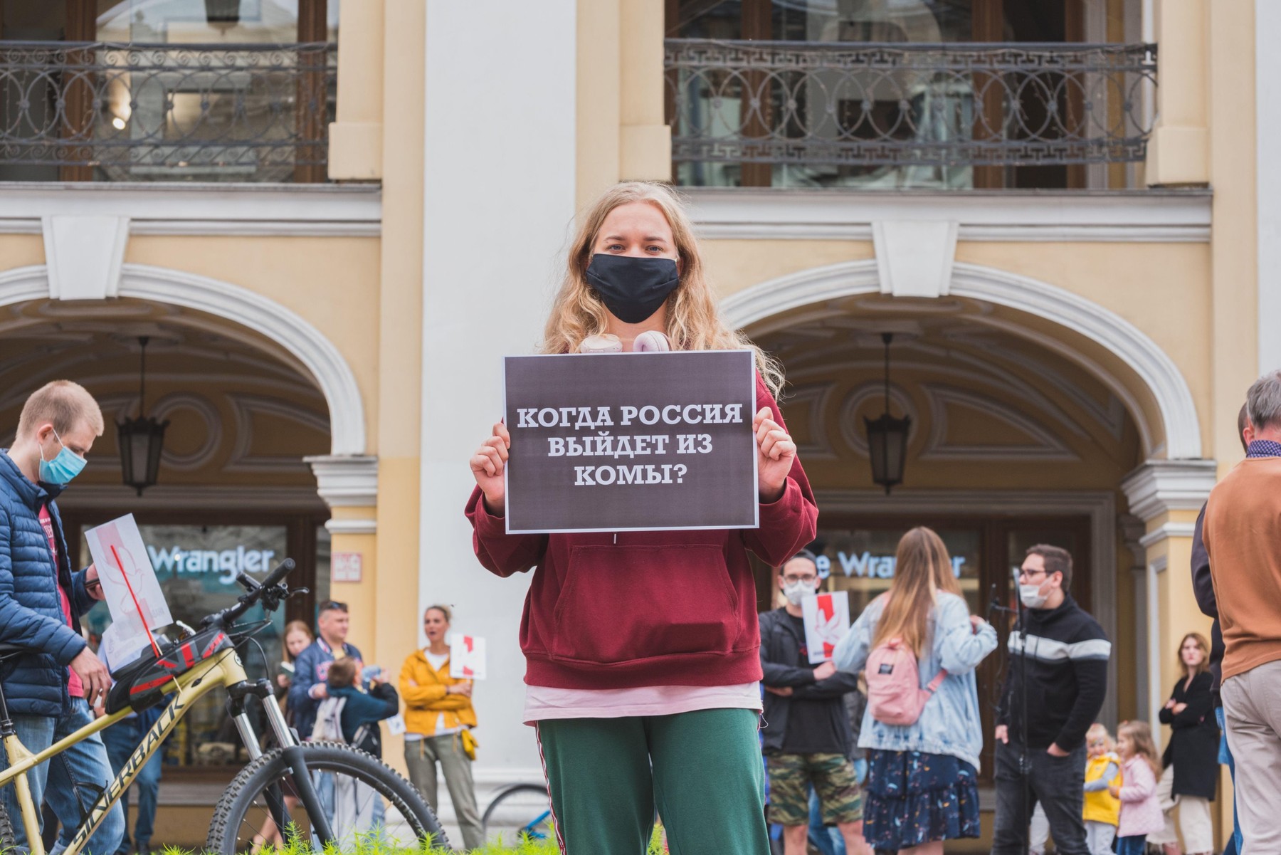 St Petersburg, Russia - August 29, 2020: a protester holds a poster "When will Russia come out of a coma?" at a rally at Gostiny Dvor.
