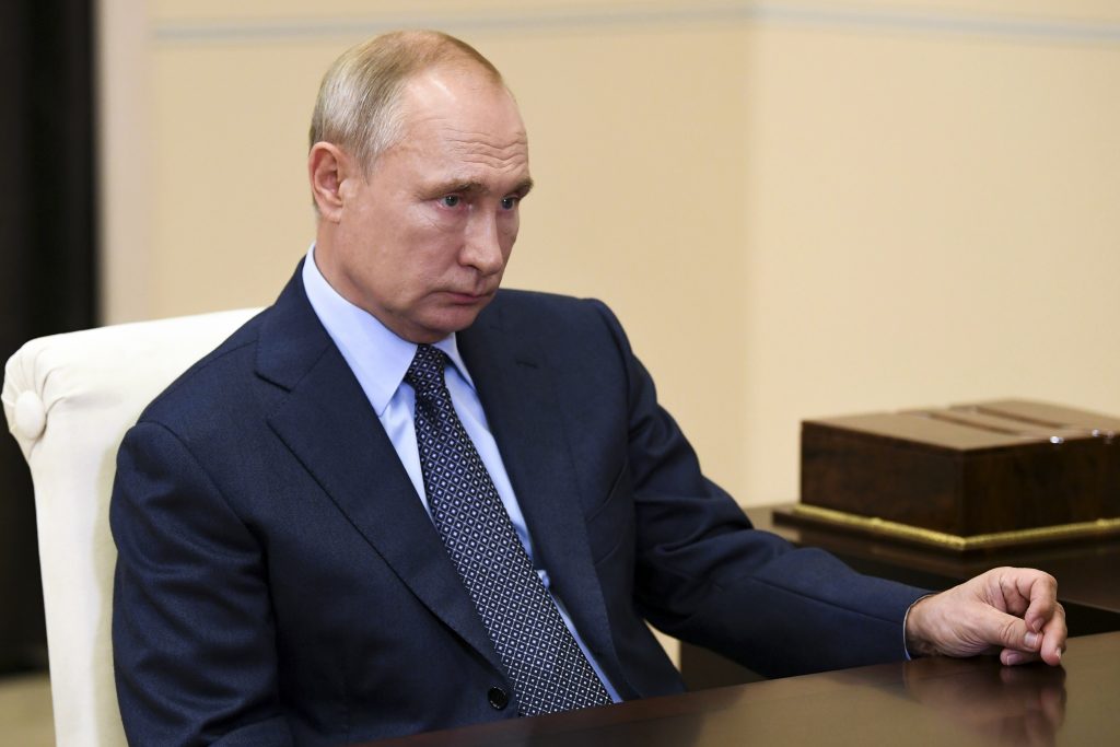 Russian President Vladimir Putin listens to Russian CEO of Rosneft oil company Igor Sechin during their meeting at the Novo-Ogaryovo residence outside Moscow, Russia, Tuesday, Aug. 18, 2020. (Alexei Nikolsky, Sputnik, Kremlin Pool Photo via AP)