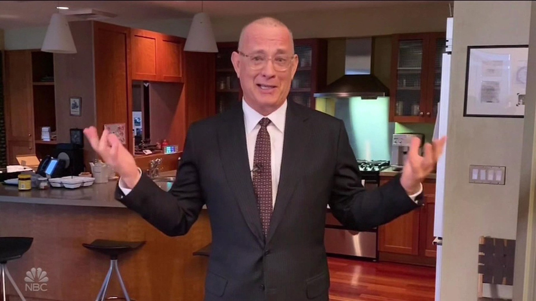A shaven headed Tom Hanks hosts Saturday Night Live from his kitchen as the show features an At Home edition
