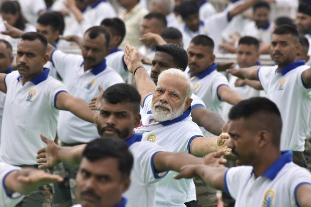 epa07662332 Indian Prime Minister Narendra Modi (C) performs yoga on the 5th International Day of Yoga in Ranchi, Jharkhand, India, 21 June 2019. This year's theme for International Yoga Day is 'Yoga for Heart.'  EPA-EFE/STR