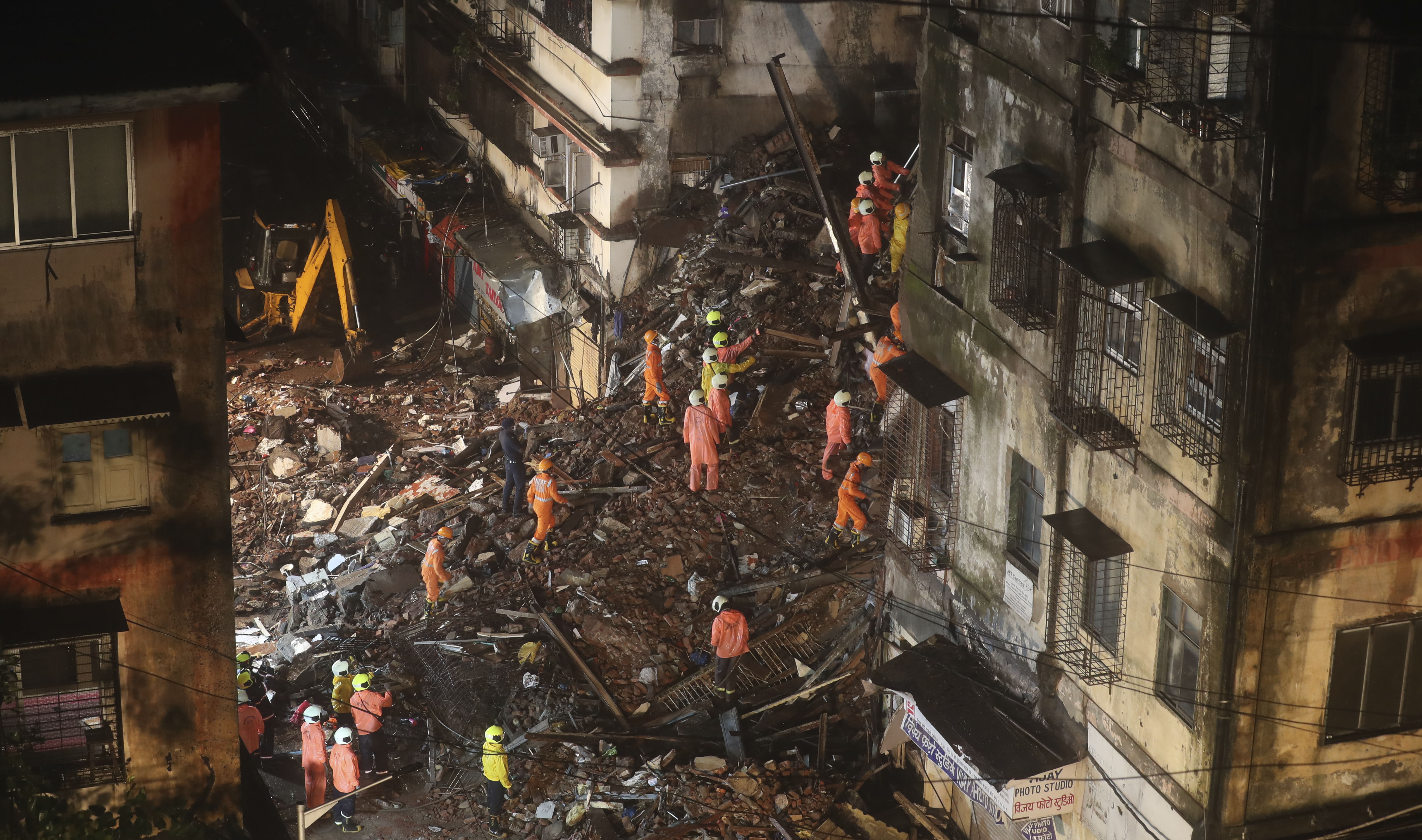 Rescuers work at the site after a six-storey residential building collapsed in Mumbai, India, Thursday, July 16, 2020. (AP Photo/Rafiq Maqbool)