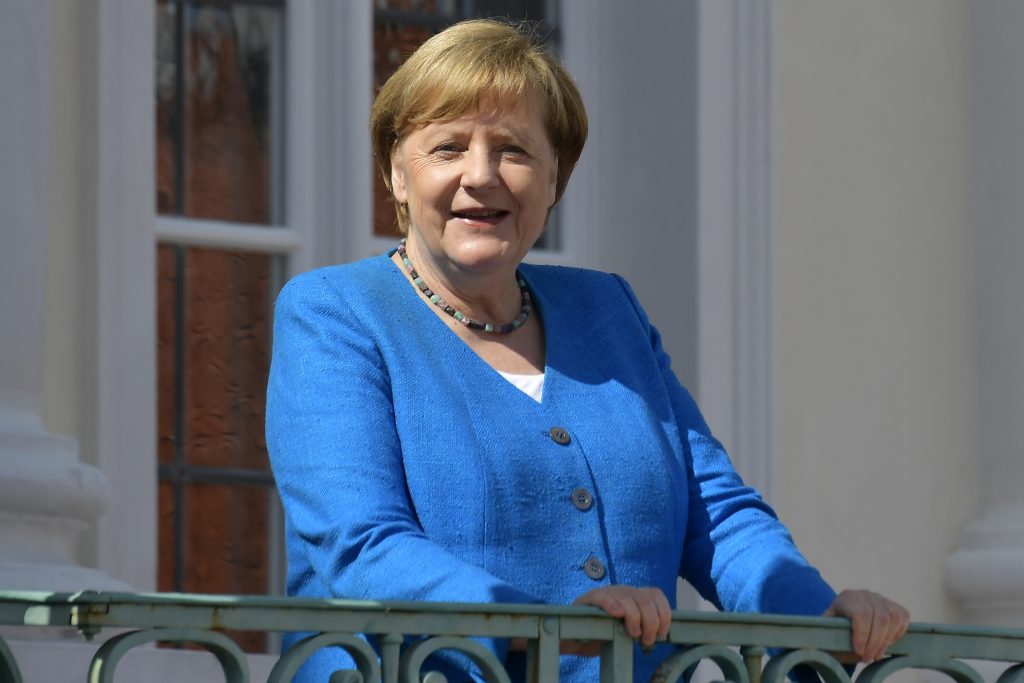 German Chancellor Angela Merkel smiles as she welcomes Italian Prime Minister Guiseppe Conte for a meeting at the German government's guest house 'Meseberg' in Gransee, north of Berlin, Germany, Monday, July 13, 2020. (Tobias Schwarz/Pool Photo via AP)