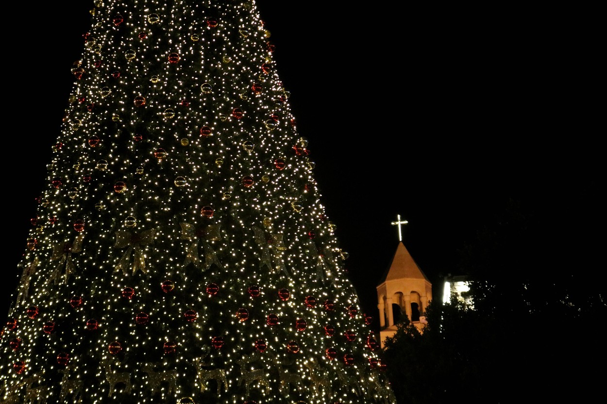 Palestinians light Christmas tree at Manger Square outside the Church of the Nativity, amid the coronavirus disease (COVID-19) outbreak