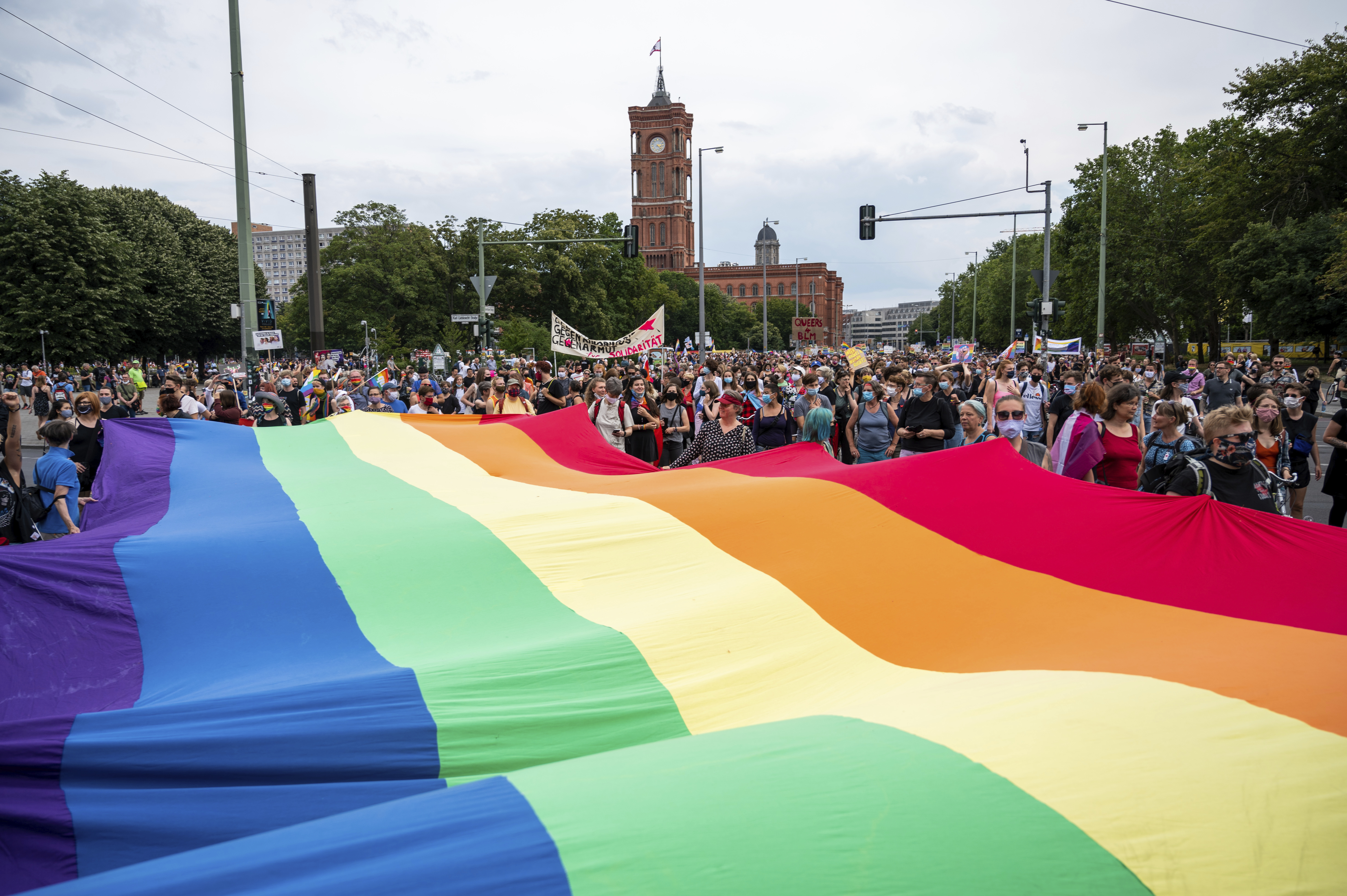 Participants hold a large rainbow flag as they take to the streets at the Dyke March for the rights of lesbian women in Berlin, Germany, Saturday, July 25, 2020. (Christophe Gateau/dpa via AP)