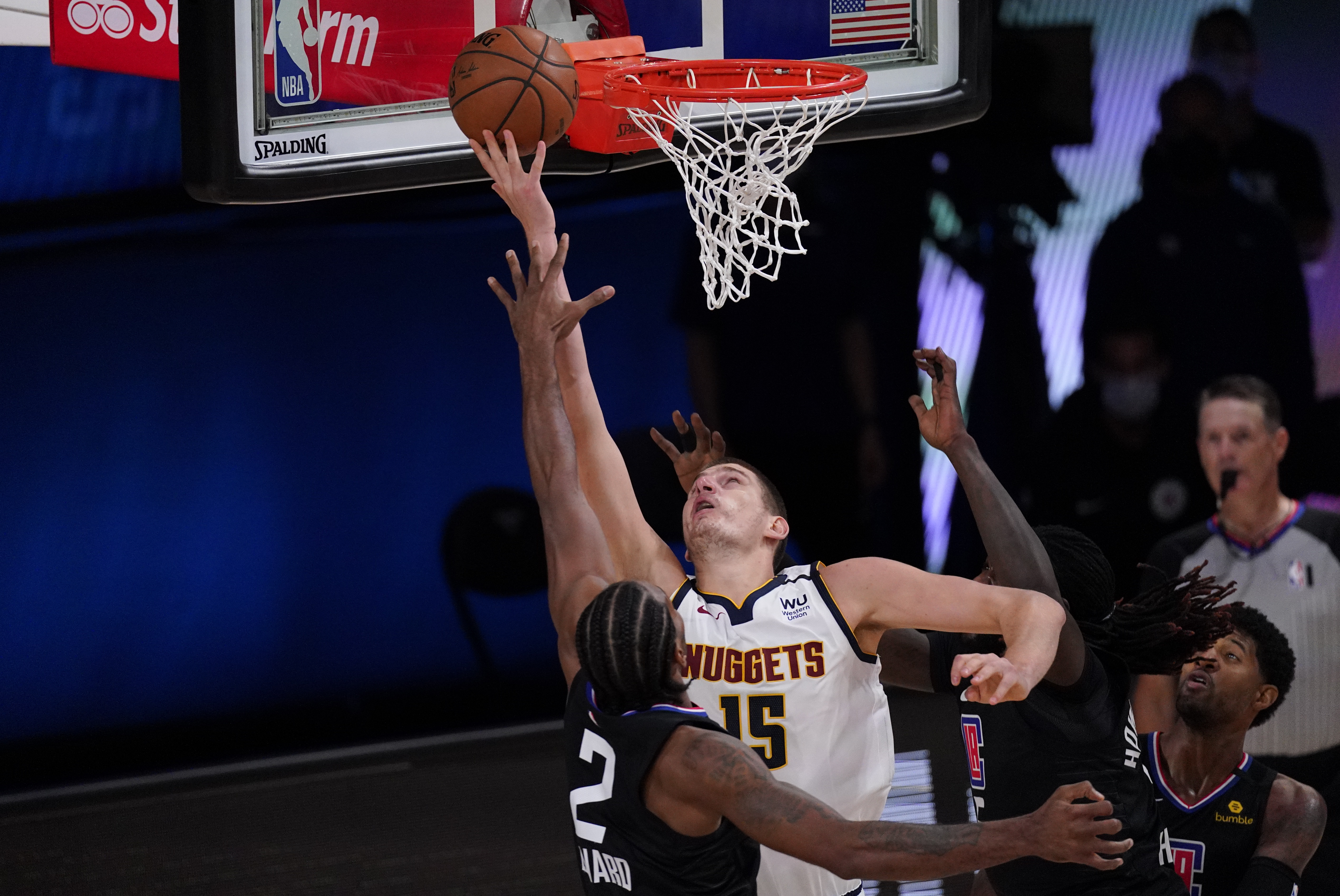 Denver Nuggets' Nikola Jokic (15) shoots over Los Angeles Clippers' Kawhi Leonard (2) during the second half of an NBA conference semifinal playoff basketball game Saturday, Sept. 5, 2020, in Lake Buena Vista, Fla. (AP Photo/Mark J. Terrill)